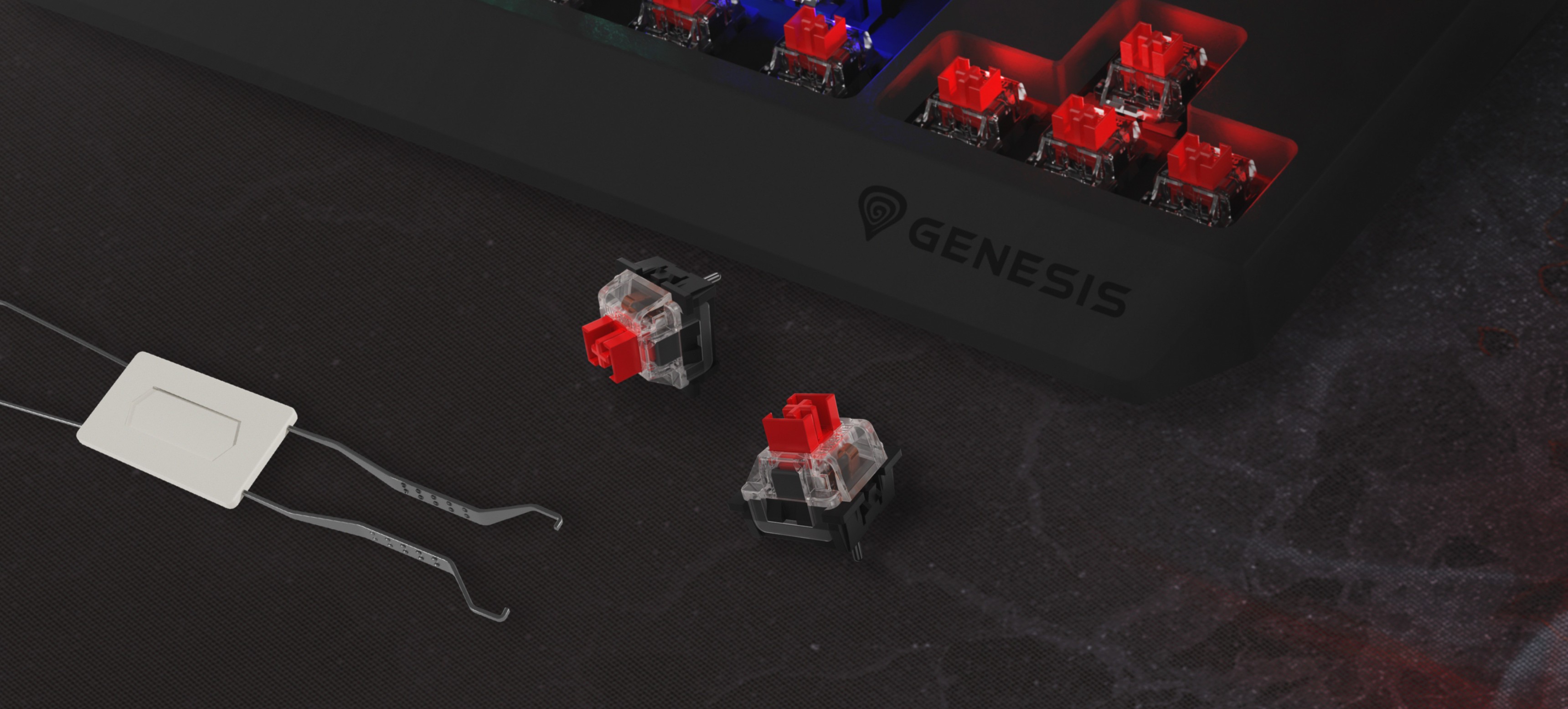 Close-up of the Genesis Thor 230 TKL Lite gaming keyboard with red Outemu mechanical switches and a switch puller tool