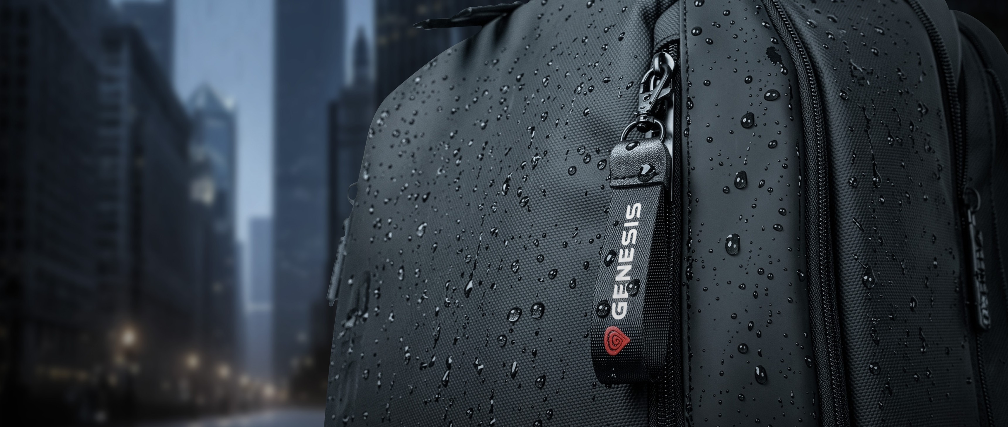 Close-up of a black bag with water droplets and a tag featuring the word Genesis.