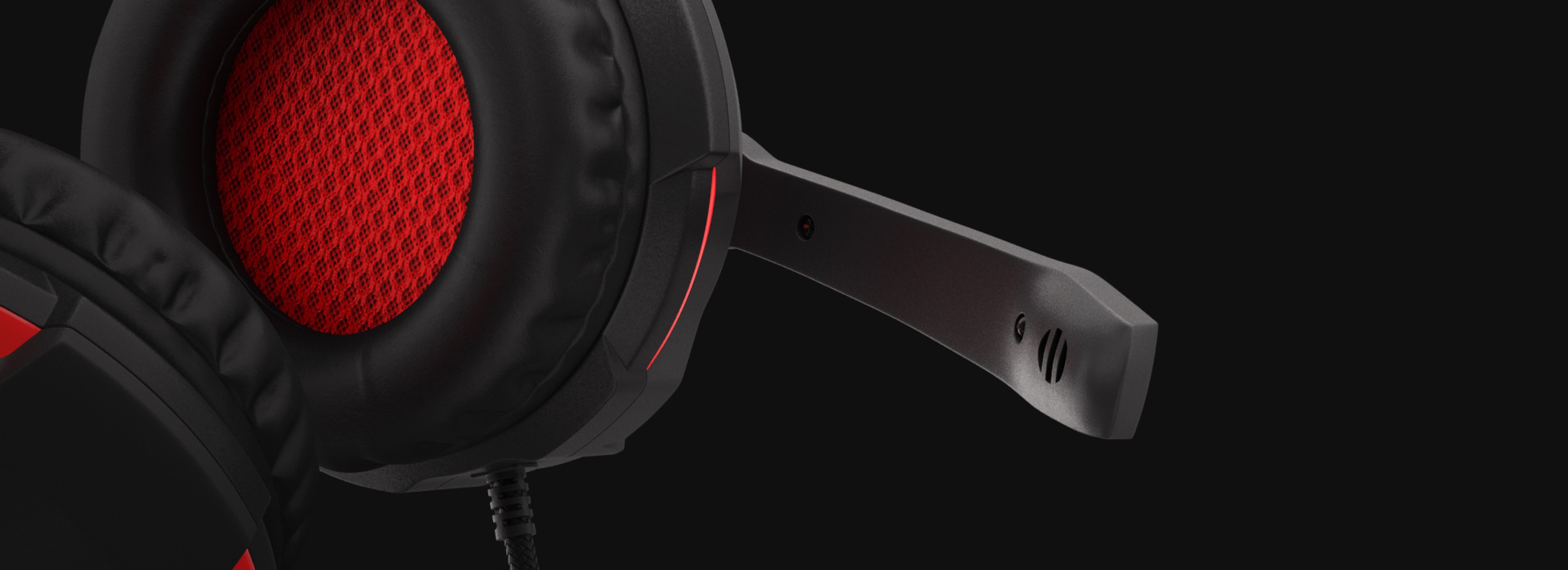 Black and red Genesis Radon 210 7.1 gaming headphones with a microphone, showcasing the ear cushion and adjustable mic