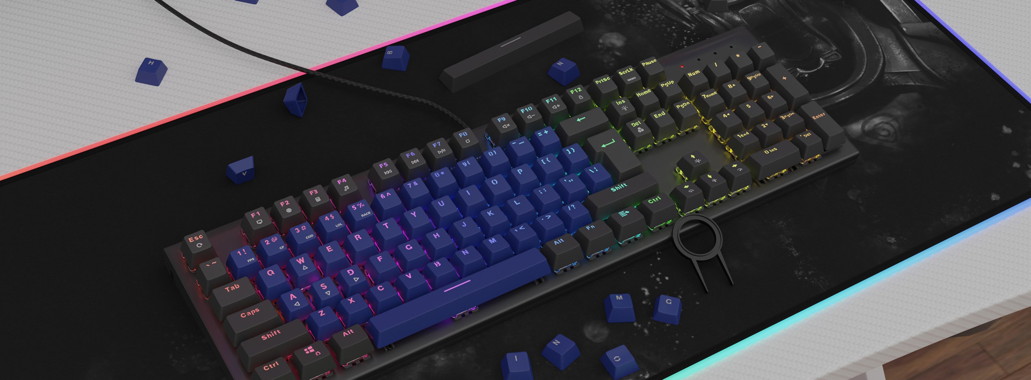 Colorful mechanical keyboard featuring blue double-shot keycaps with scattered blue keycaps on a gaming mouse pad