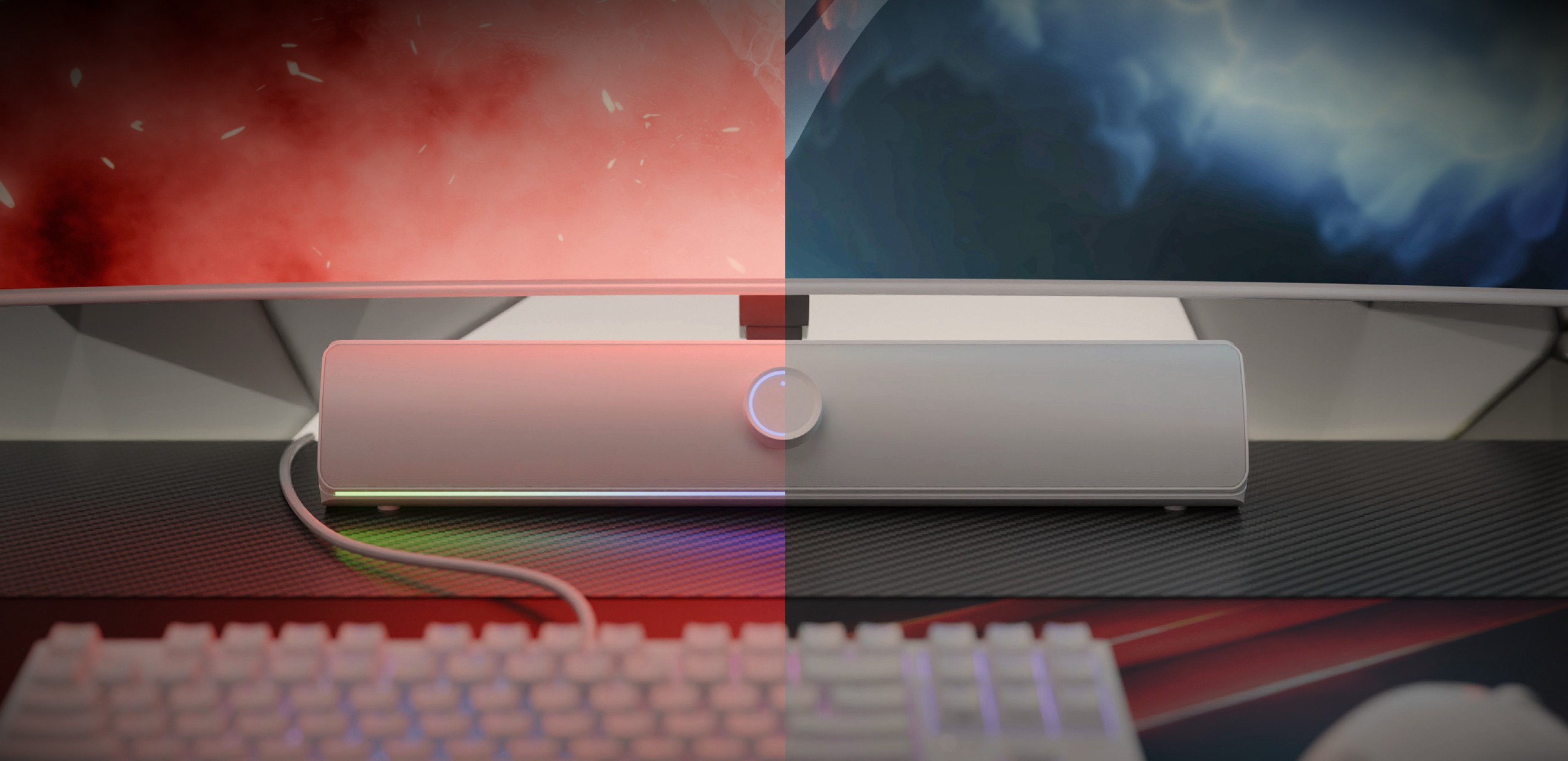 Bluetooth soundbar in white, showcasing a central control knob, positioned on a desk with a keyboard and monitor backdrop