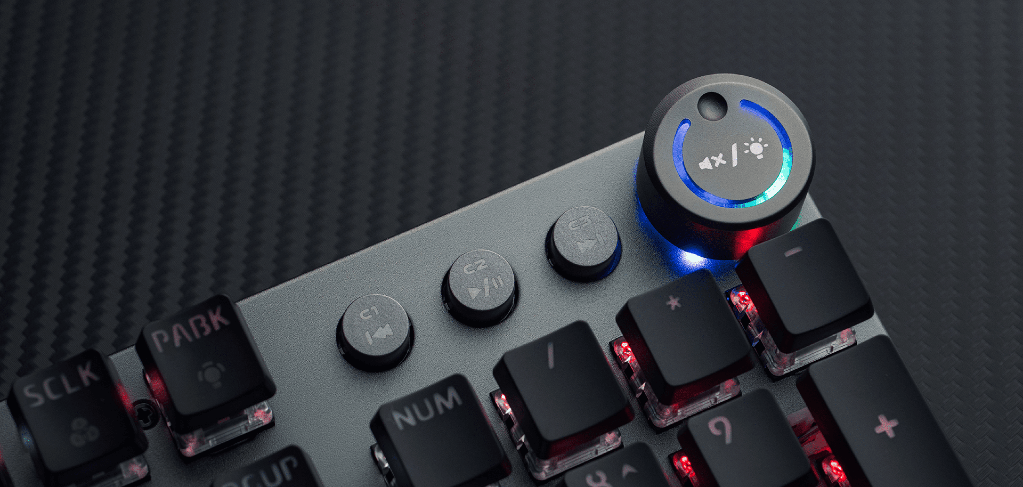Close-up of a keyboard showing colorful lights and several control buttons.