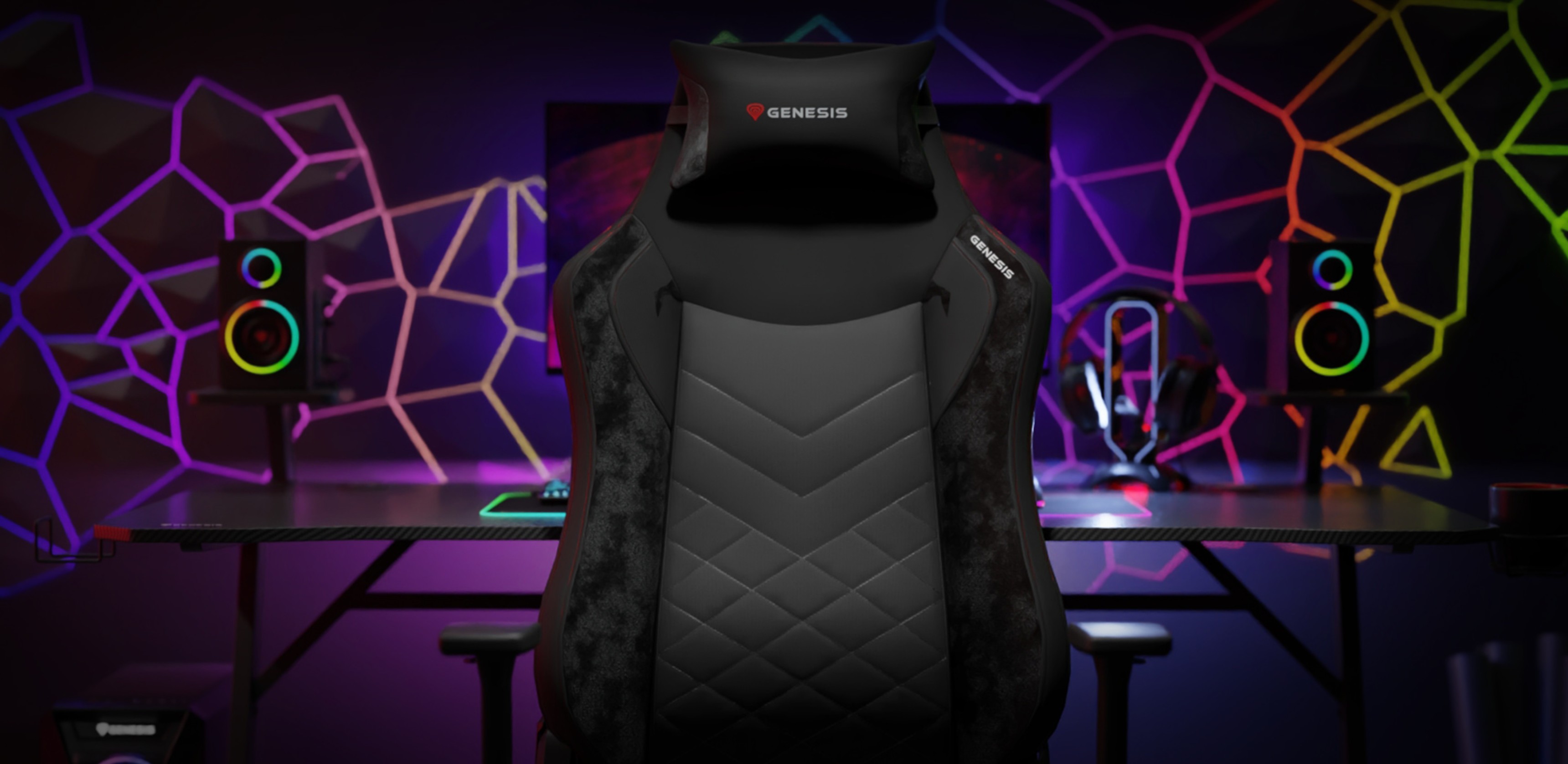 Black Genesis Nitro 890 G2 gaming chair positioned in a vibrant gaming setup with colorful LED speakers and a futuristic backdrop