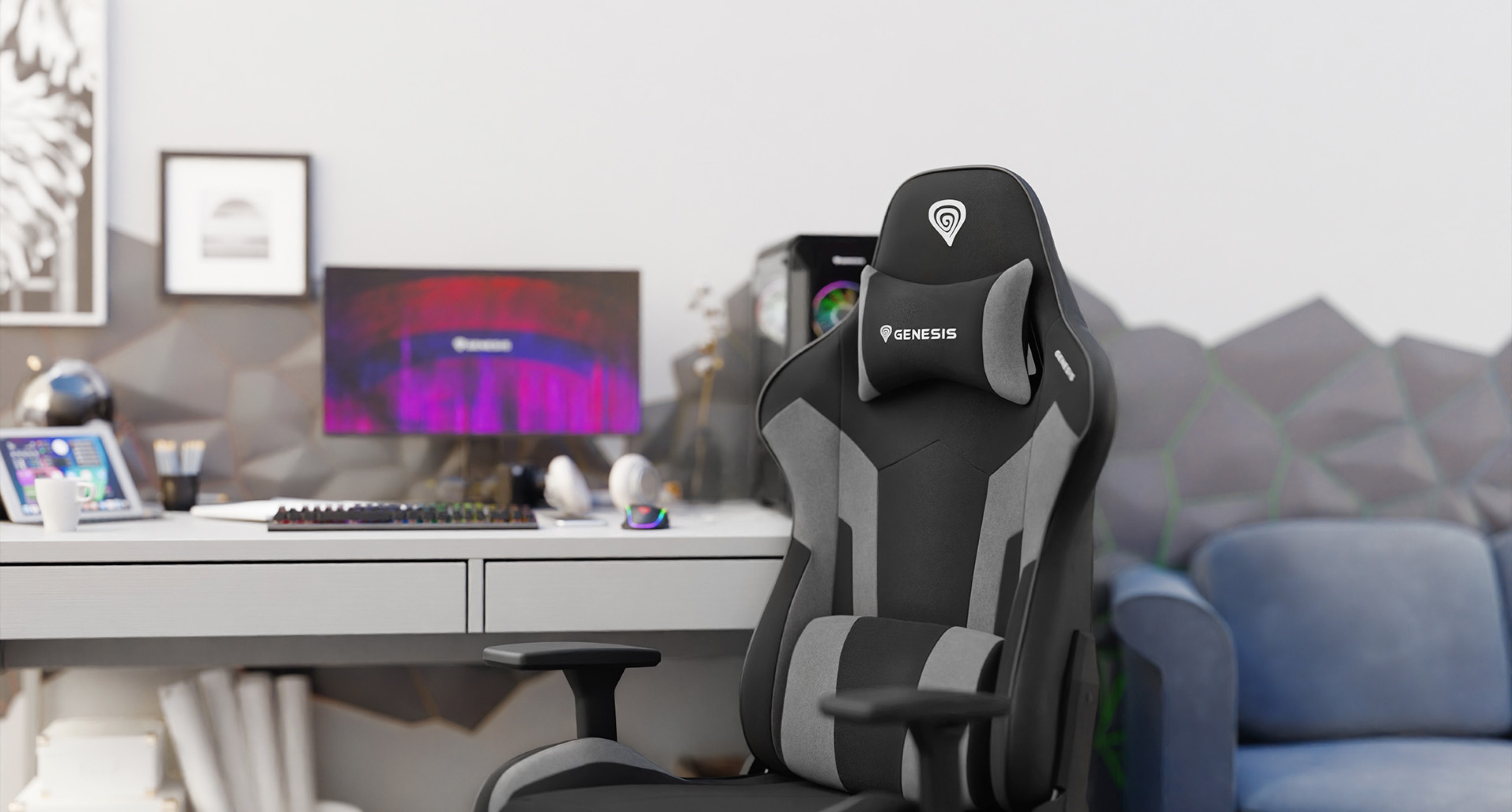 Black and gray gaming chair positioned beside a desk with a computer setup and colorful decor in the background