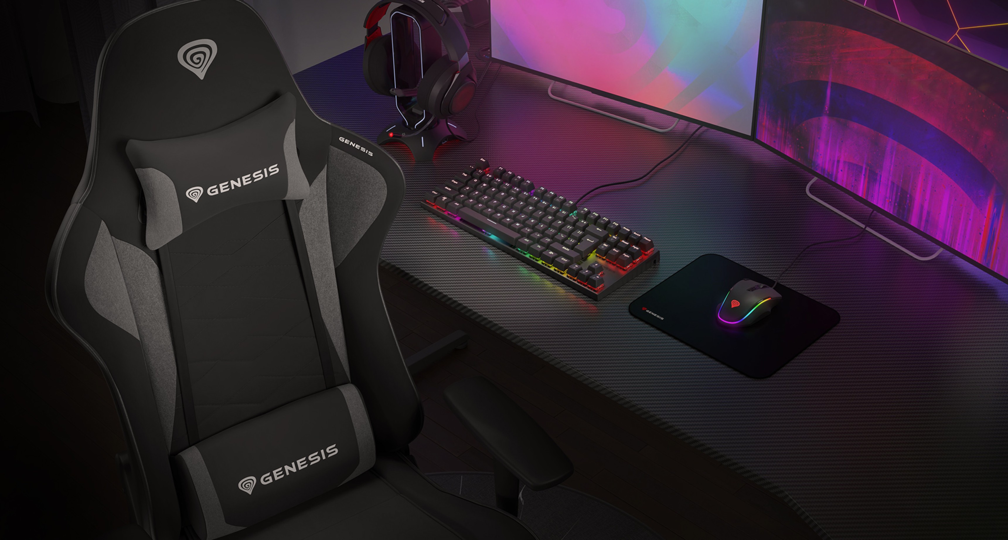 Black and gray gaming chair next to a keyboard, mousepad, and headset on a stylish desk with colorful LED lighting
