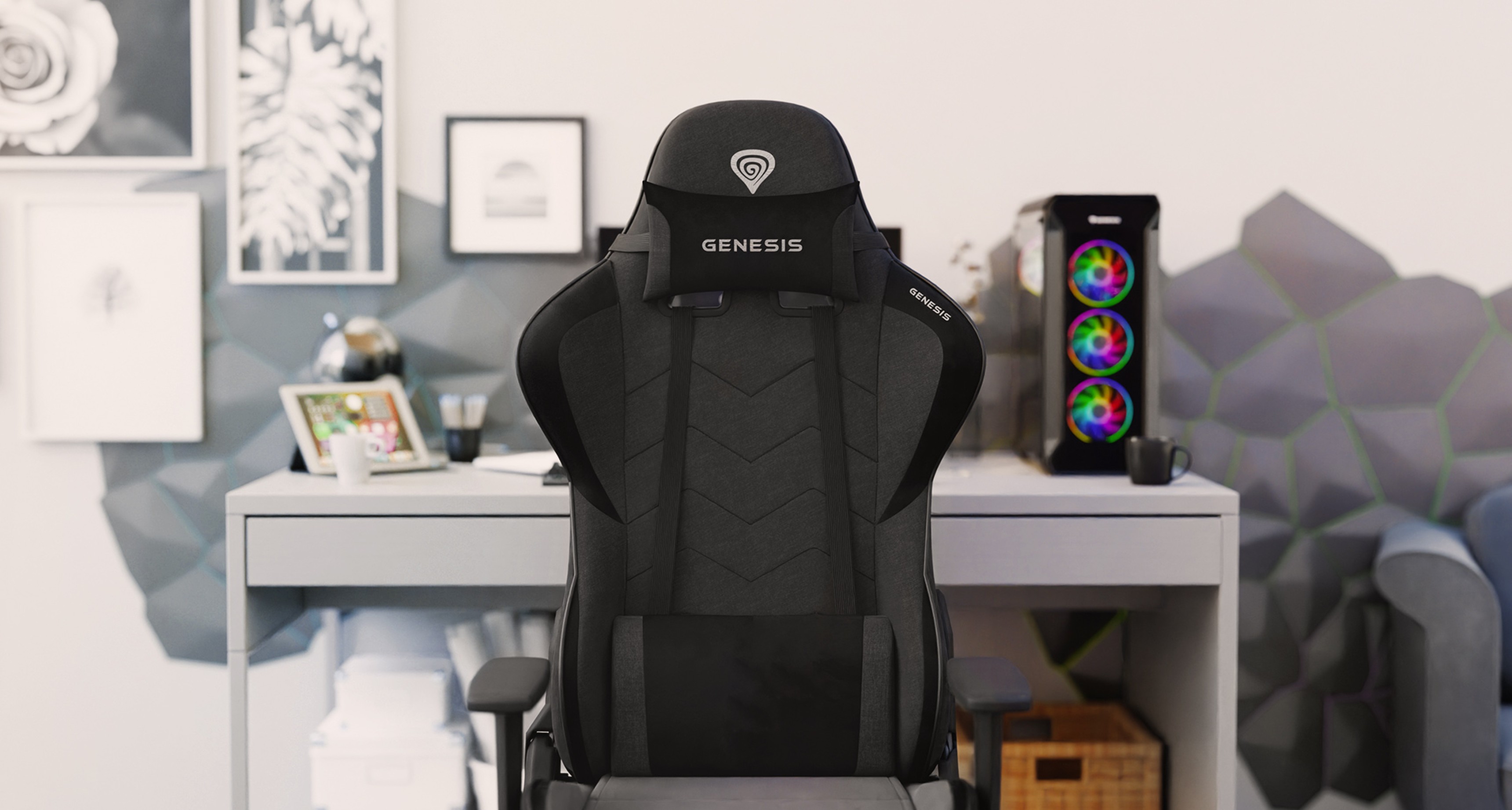 Gray Genesis Nitro 550 G2 gaming chair positioned in an office setting with a desktop and decorative wall art in the background