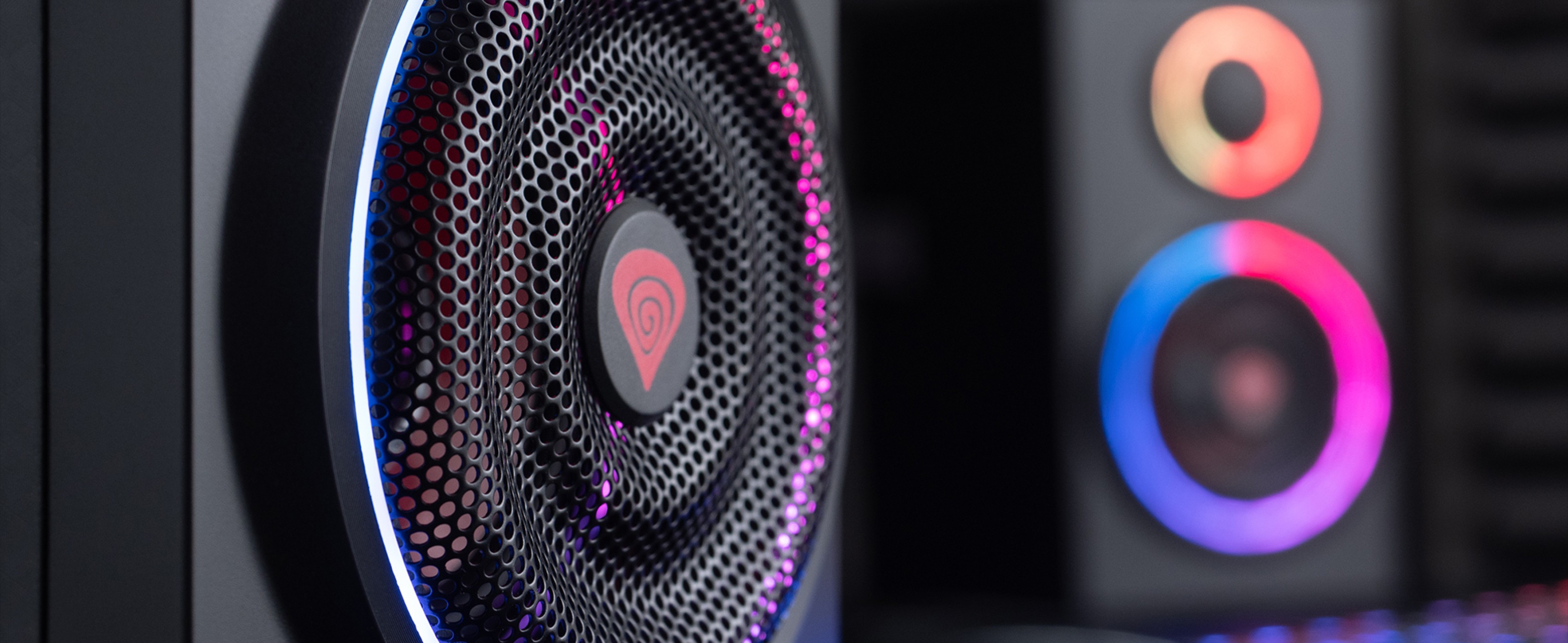 Close-up of Genesis Helium 300BT 2.0 Bluetooth speakers with RGB lighting accents and a mesh speaker grille