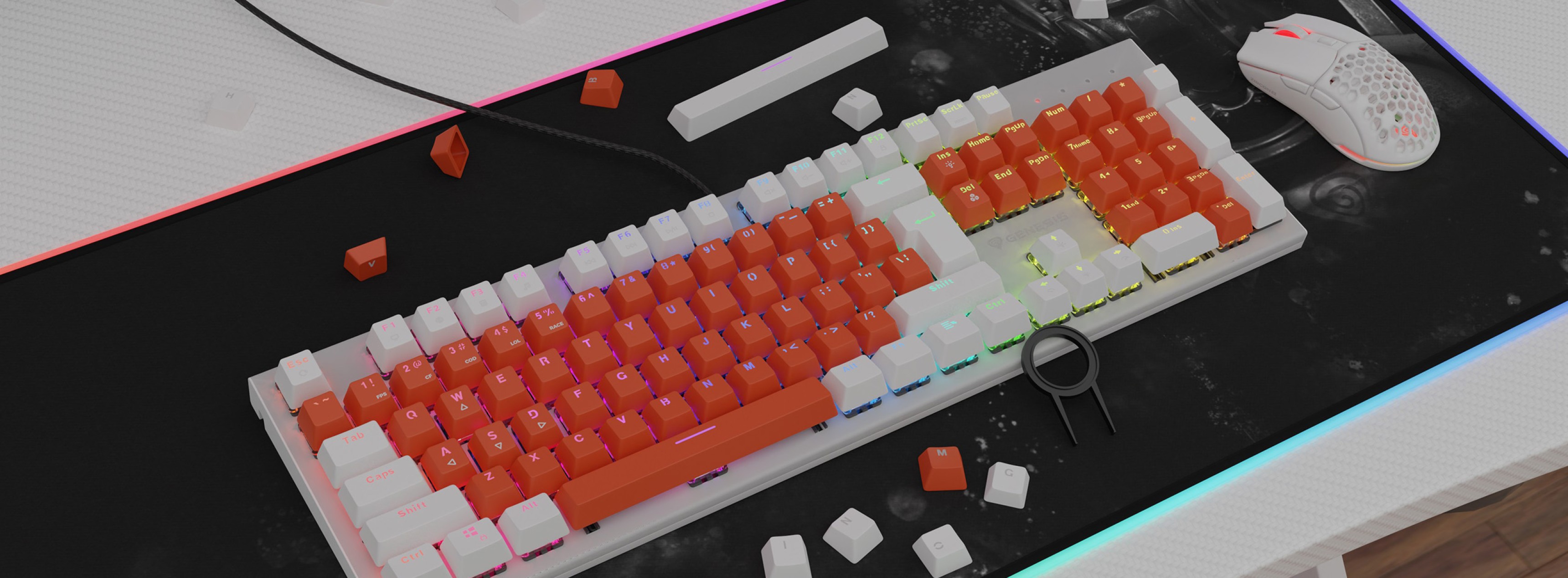 Orange and white double shot keycaps on a mechanical keyboard, with scattered keycaps and a white gaming mouse on a black mat