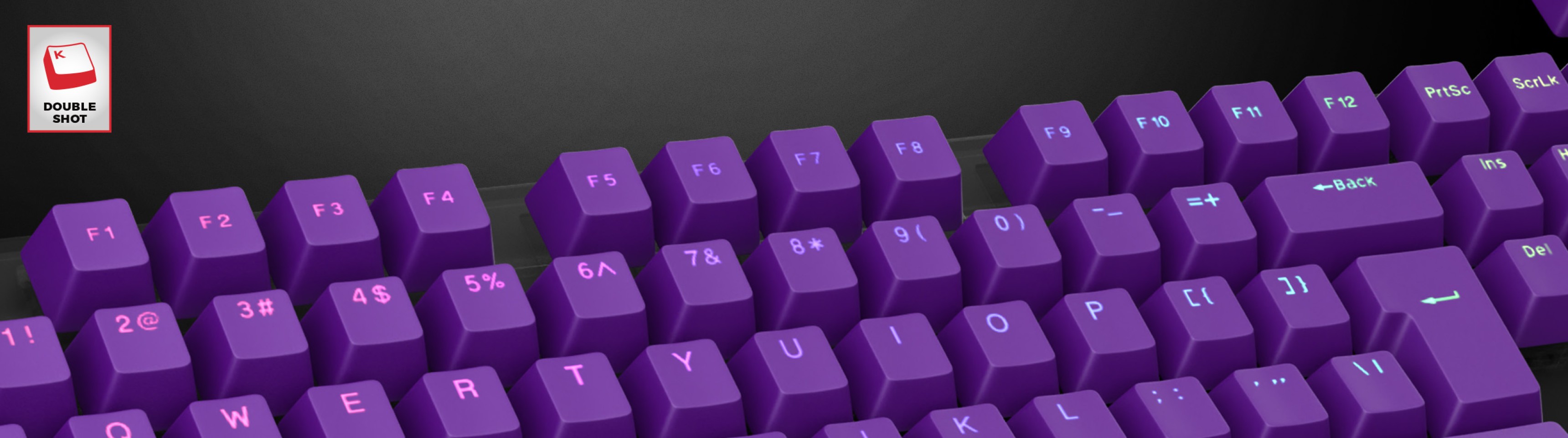 Purple double-shot keycaps displaying alphanumeric characters and symbols, designed for a keyboard layout