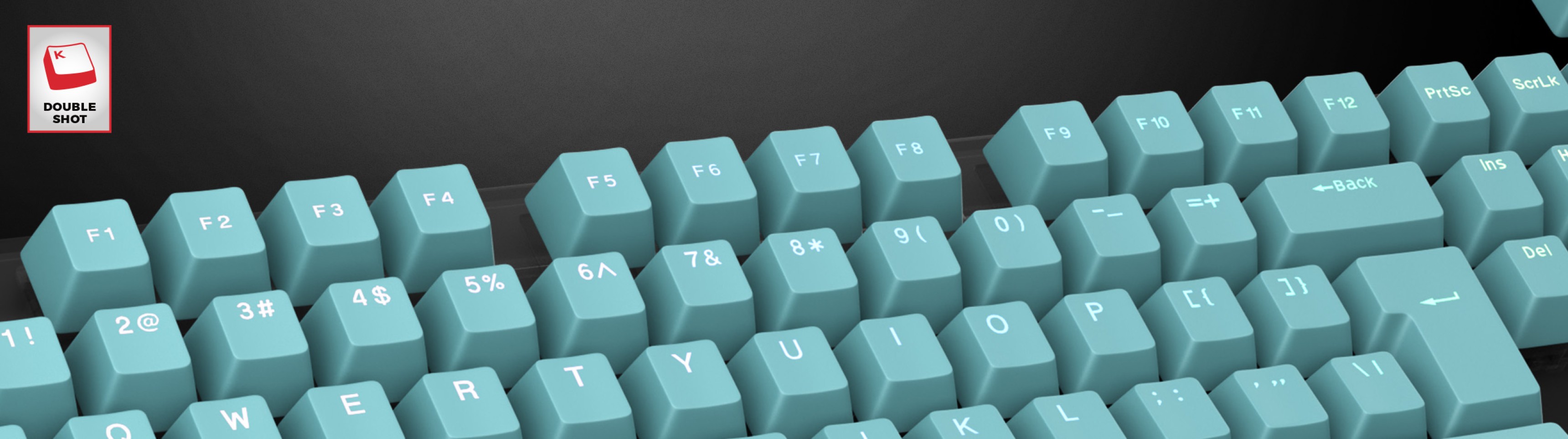 Mint green double shot keycaps arranged on a keyboard, showcasing letter and number engravings