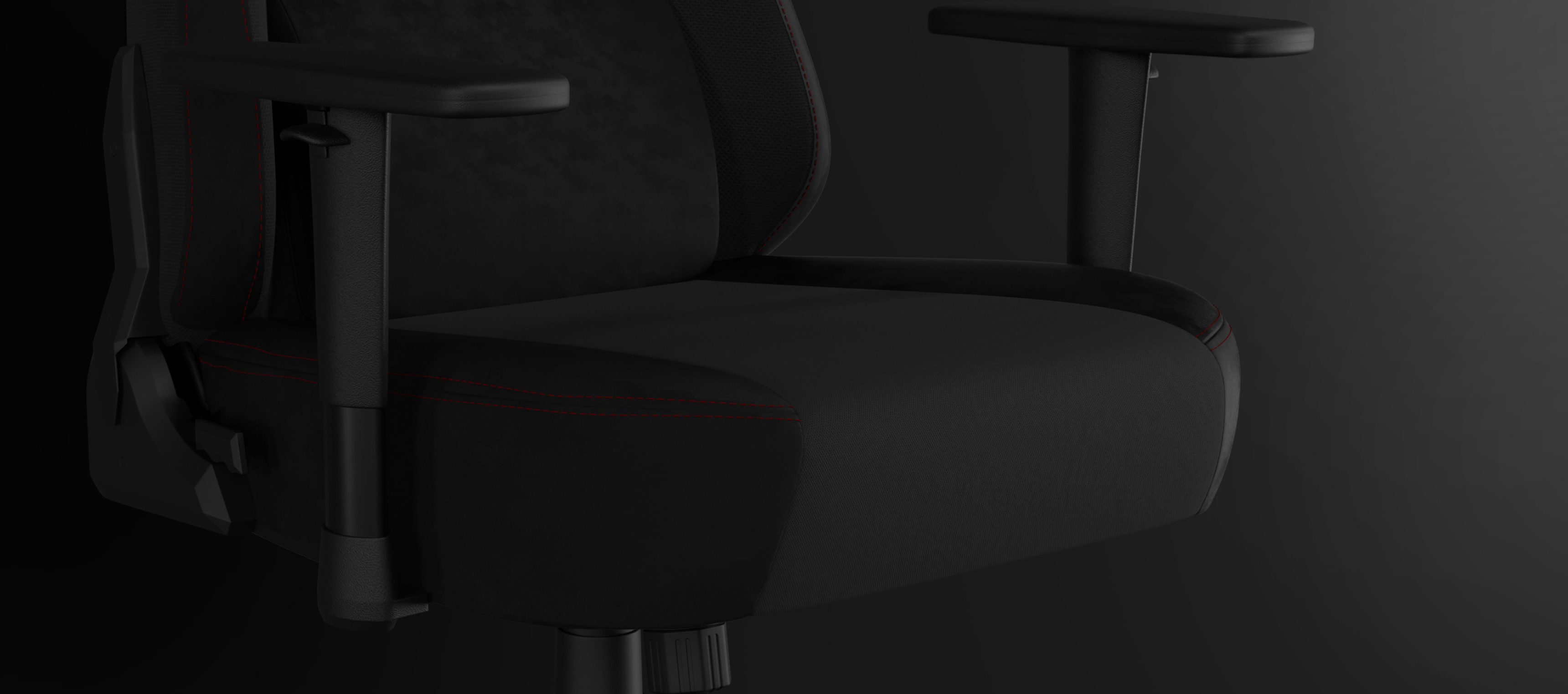 Black office chair with armrests and contrasting stitching on the seat fabric.