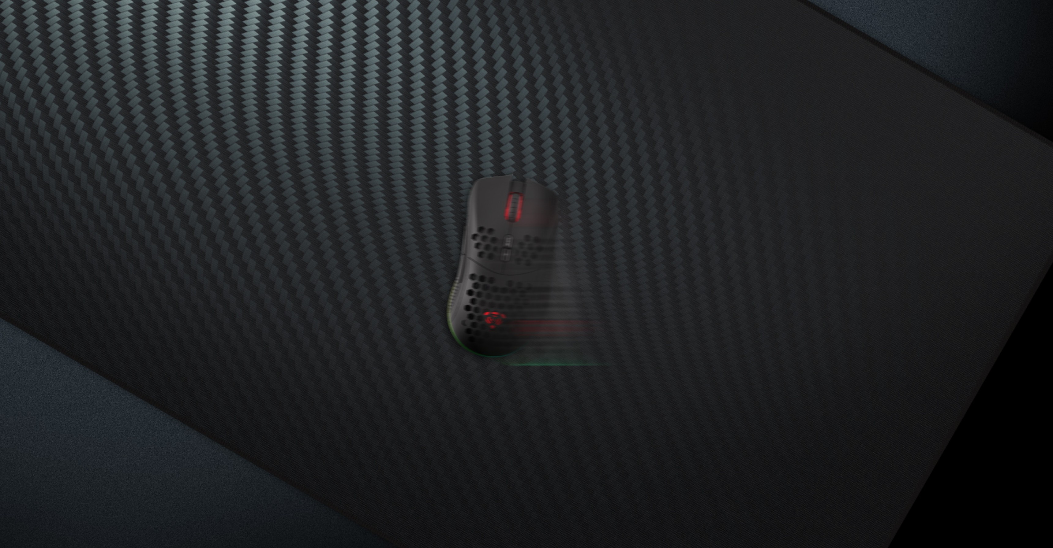 Textured black mouse pad with a carbon fiber design and a gaming mouse positioned on it, emphasizing its surface