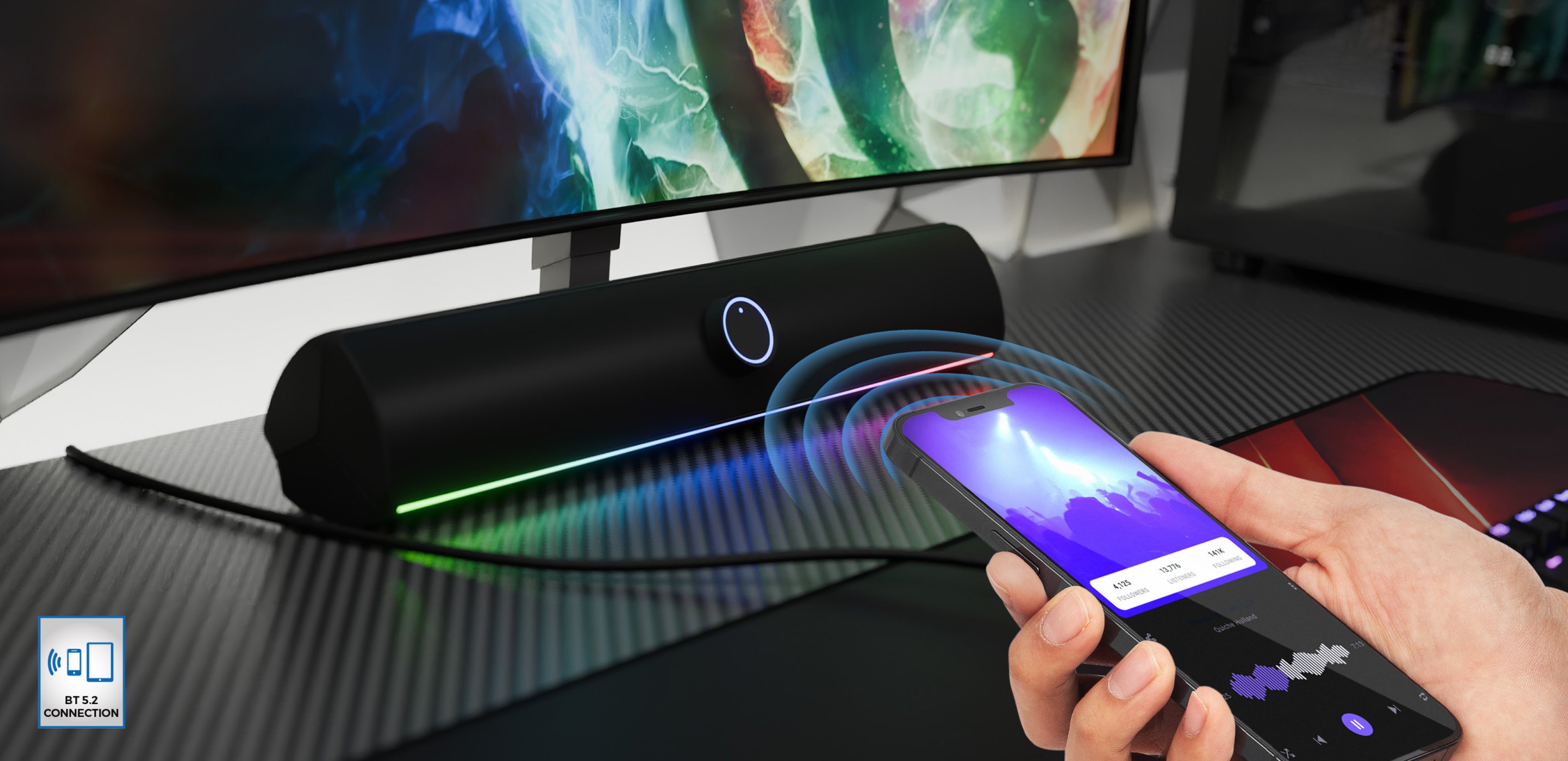 Bluetooth soundbar in black with LED lighting, being wirelessly controlled by a smartphone on a desk