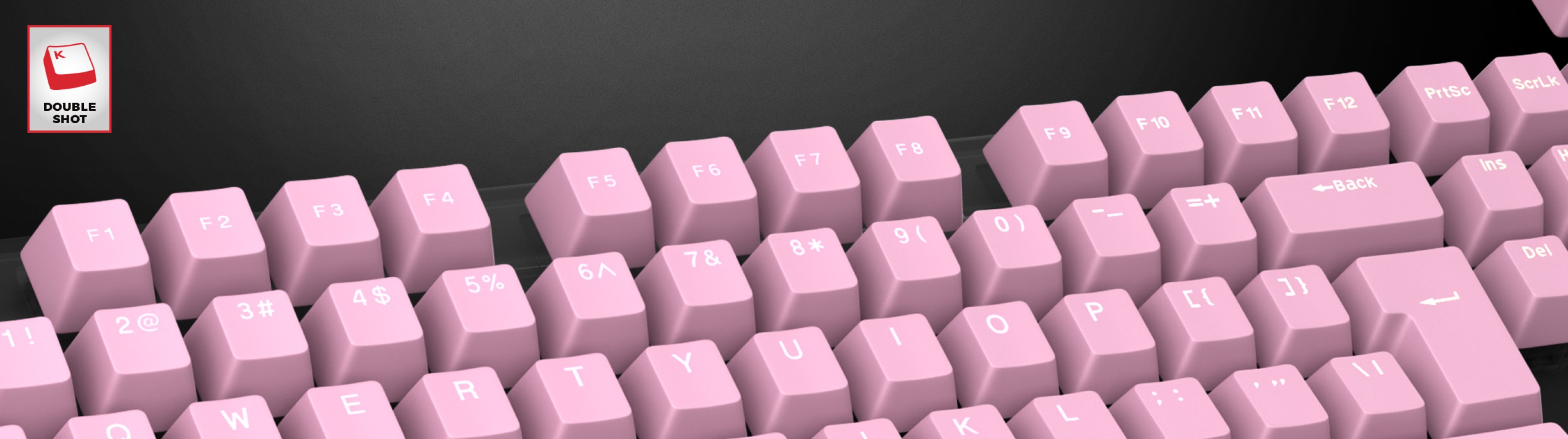 Pale pink double shot keycaps arranged on a keyboard, featuring clear legends for each key