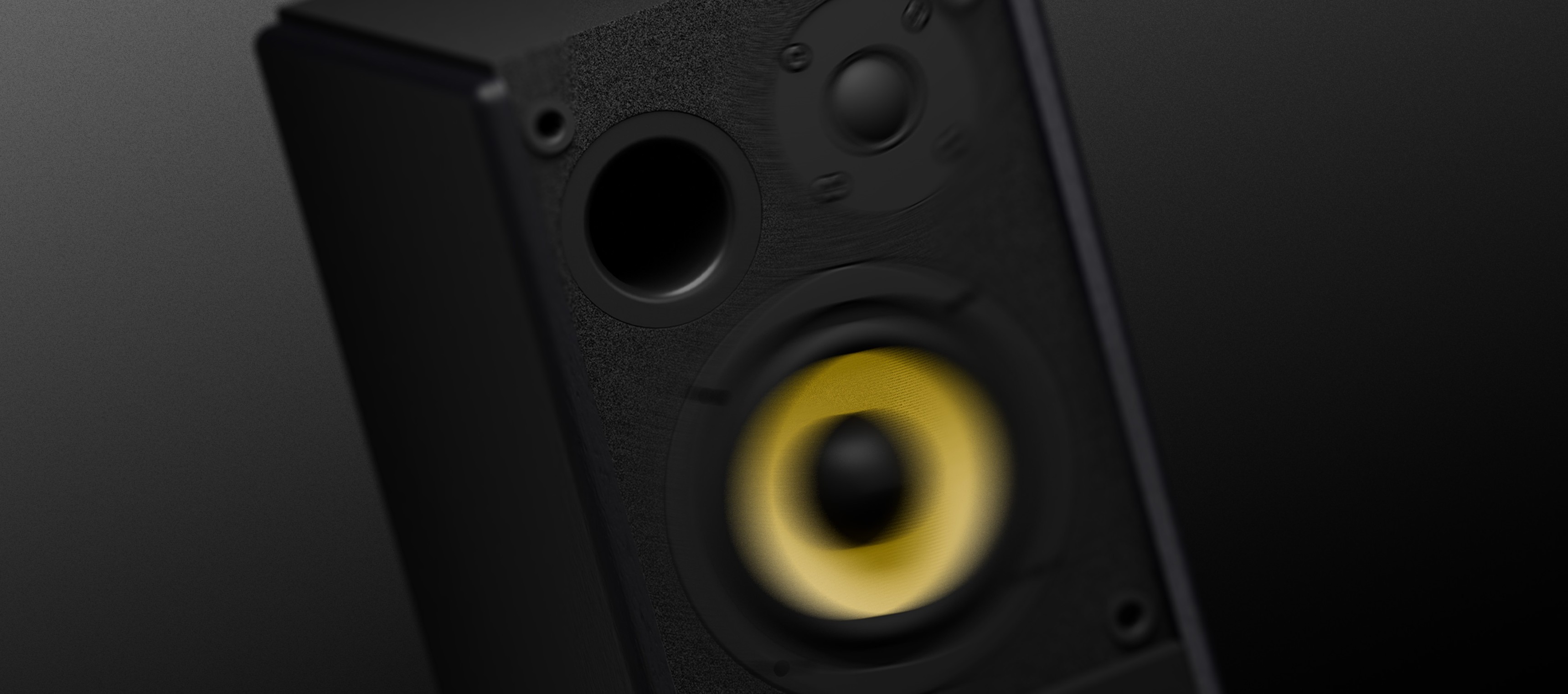 Black speaker with a yellow cone and two control knobs for sound adjustment.