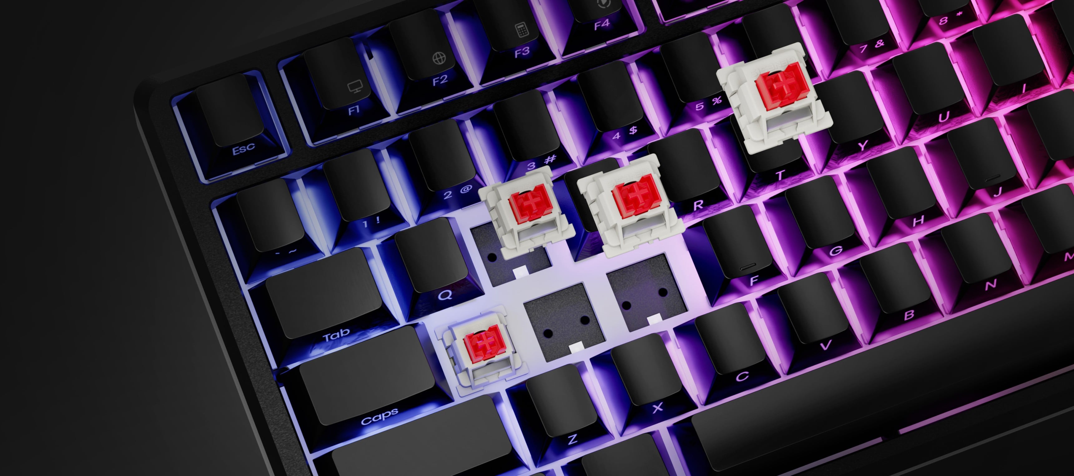 Keyboard with glowing keys and several mechanical switches removed and placed on top.