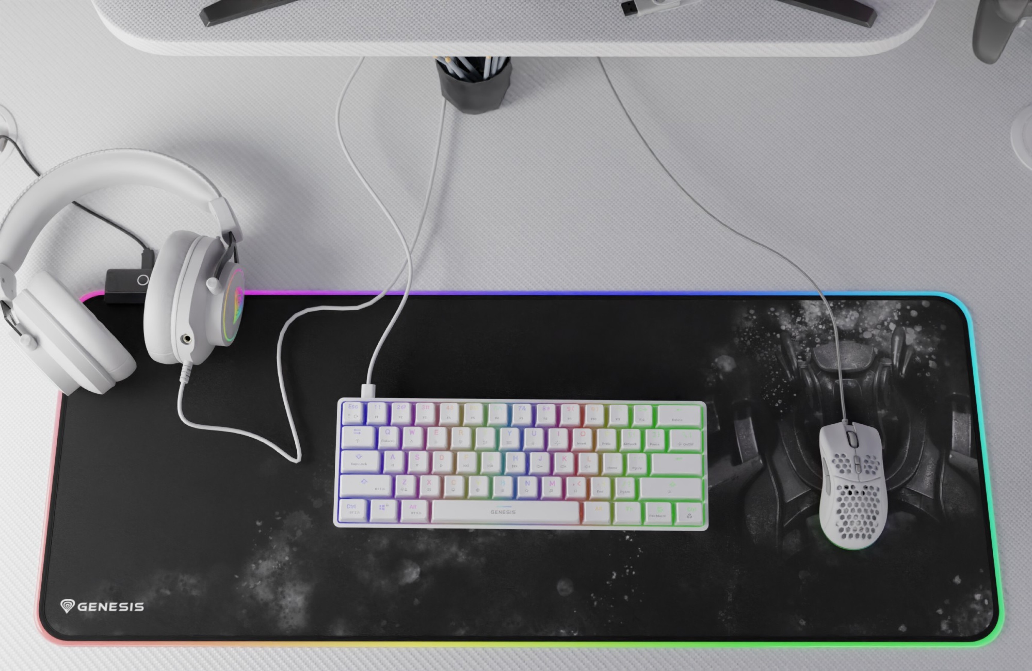A large mouse pad with a keyboard, mouse, and headphones arranged on top in a workspace.