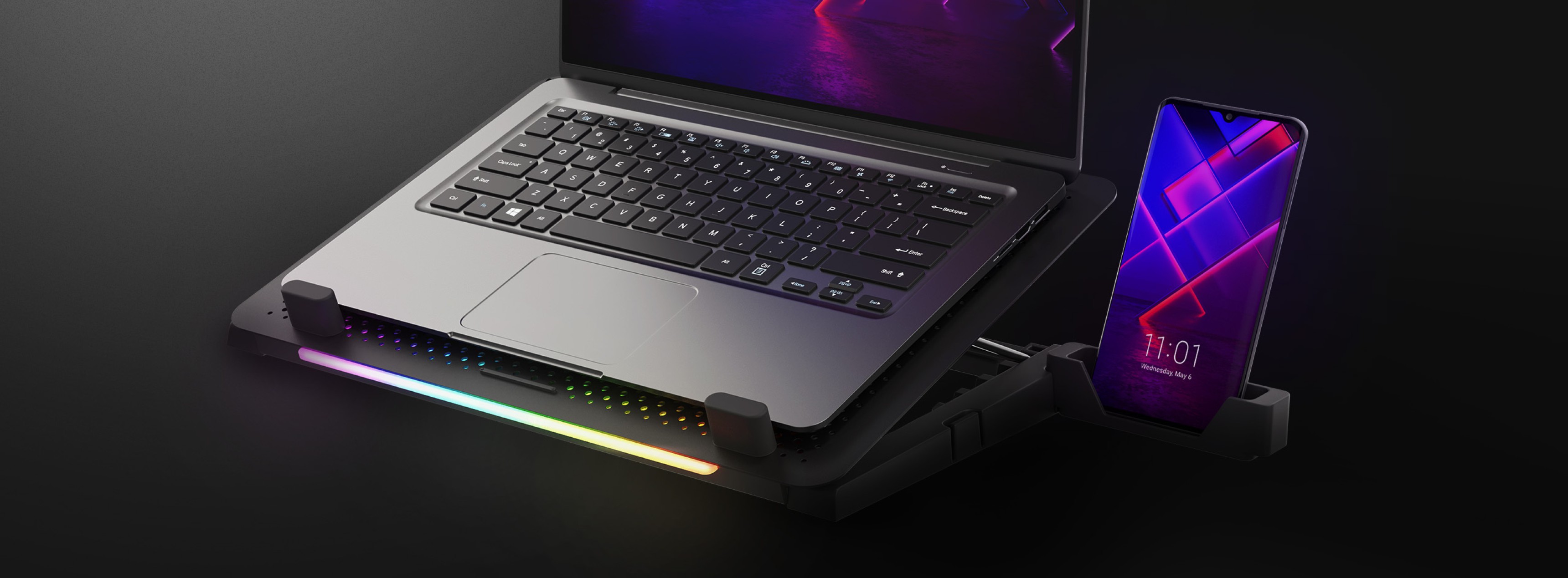 Cooling laptop stand Genesis Oxid 450 with RGB lighting, a fan, and two USB ports, featuring a laptop and smartphone