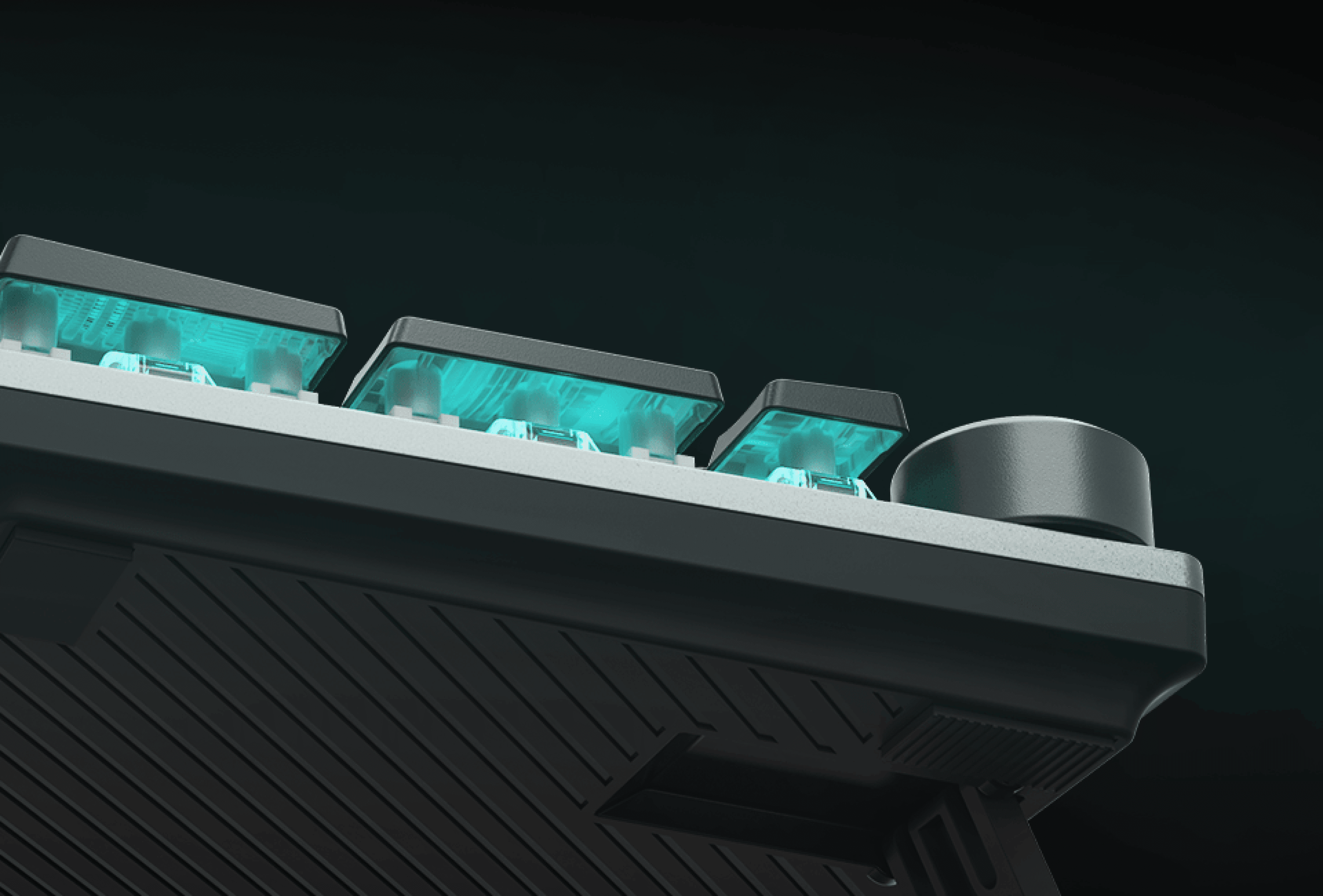 Close-up of a gaming keyboard with glowing keys and a control knob on the side.