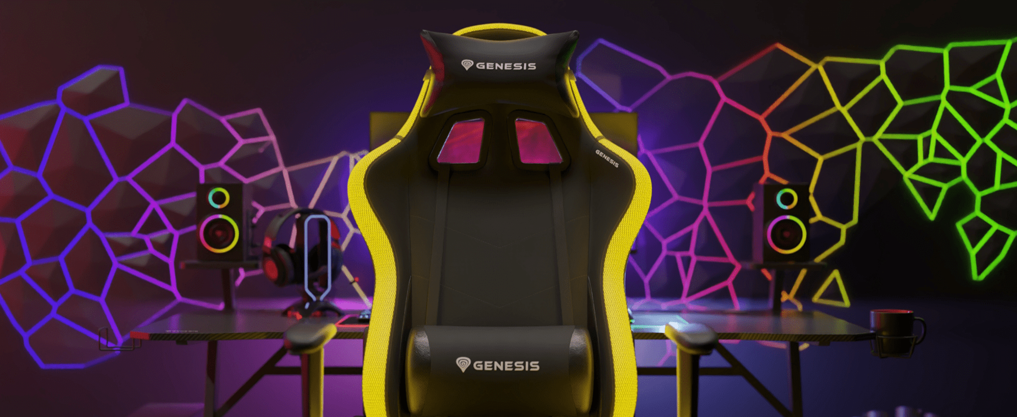 Black Genesis Trit 500 gaming chair with RGB lighting, positioned in front of a colorful, geometric backdrop and gaming setup