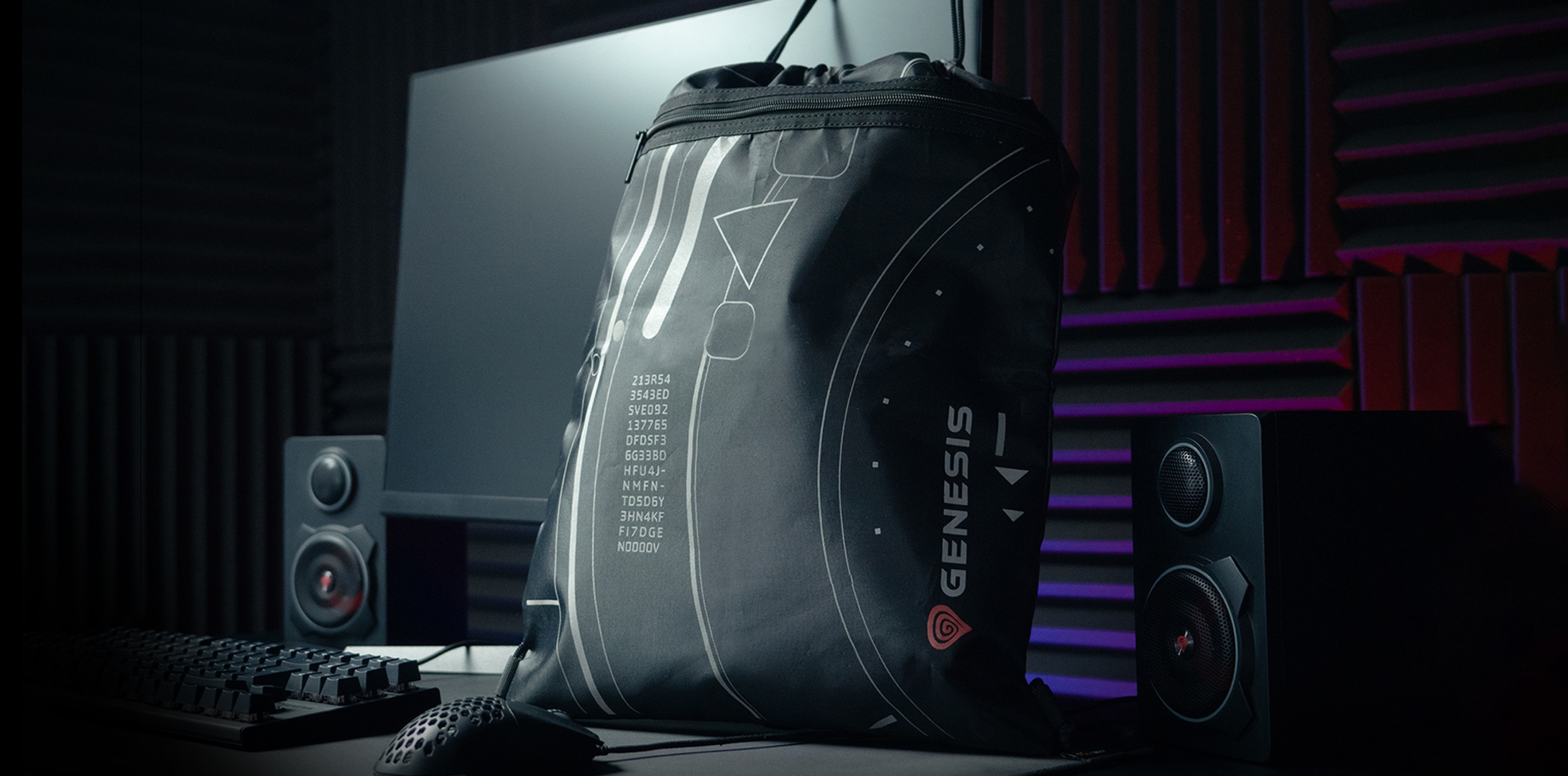 Black Genesis G2 sports backpack displayed on a desk with a computer and speakers in a stylized environment