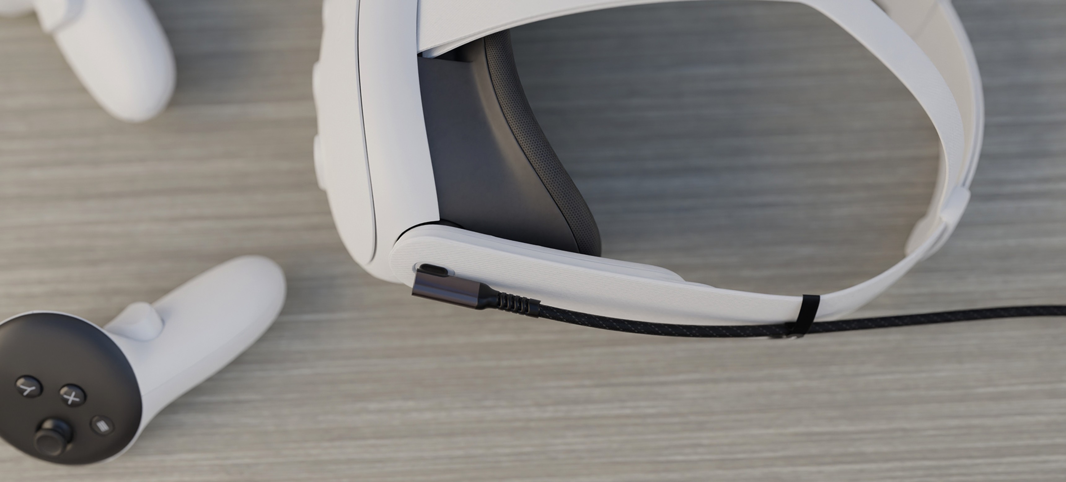 Black USB-C male-to-male cable, 3m long, positioned near a white VR headset and controller on a wooden surface