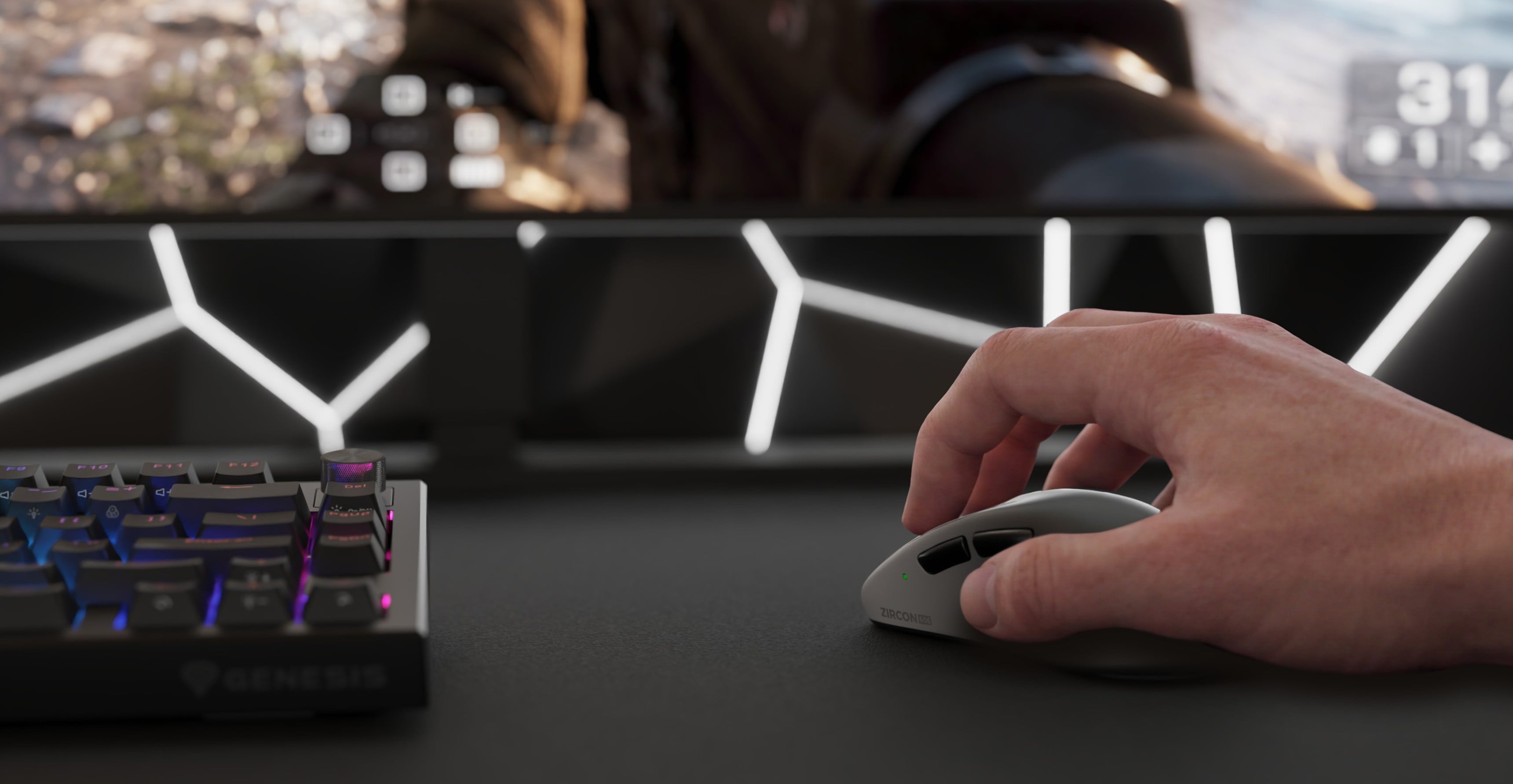 Hand using a computer mouse next to a keyboard and a screen displaying a game.