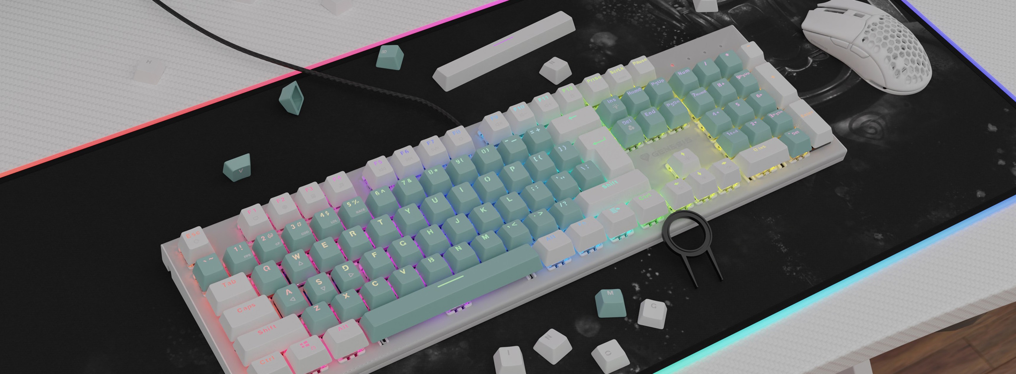 Mint green double-shot keycaps on a backlit keyboard, surrounded by small white keycap pieces and a gaming mouse
