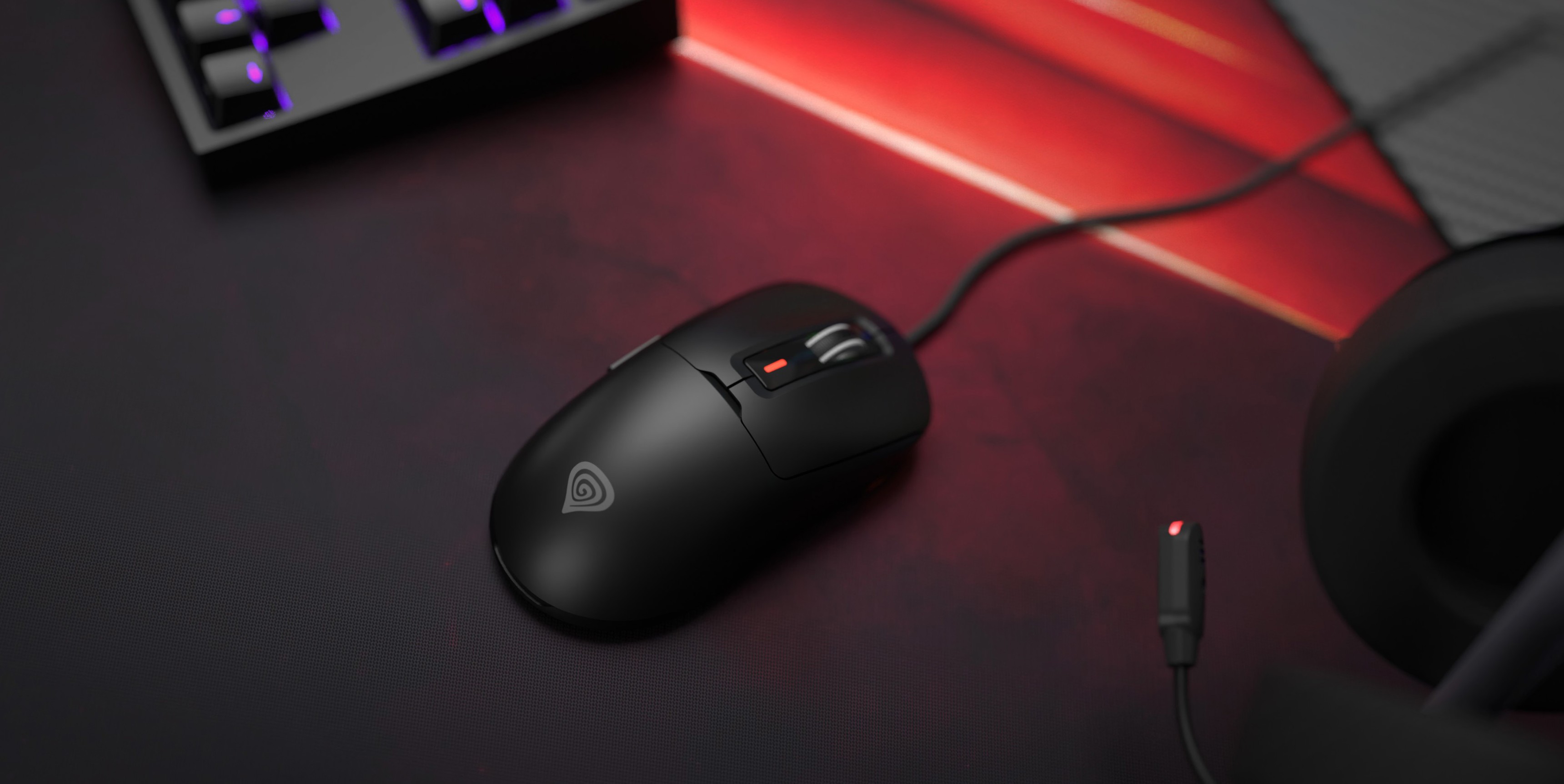 Black Genesis Krypton 660 gaming mouse with RGB lights, 12000 DPI, and a programable design, on a dark gaming surface