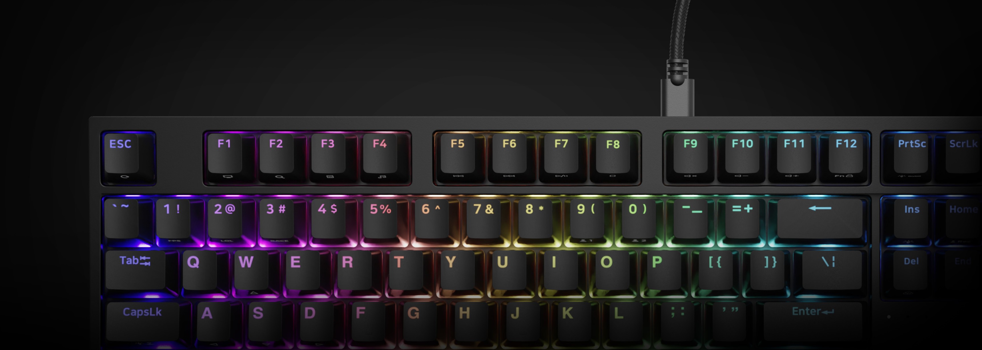 Black mechanical gaming keyboard with RGB backlighting and Outemu Peach Silent switches, showing colorful illuminated keys