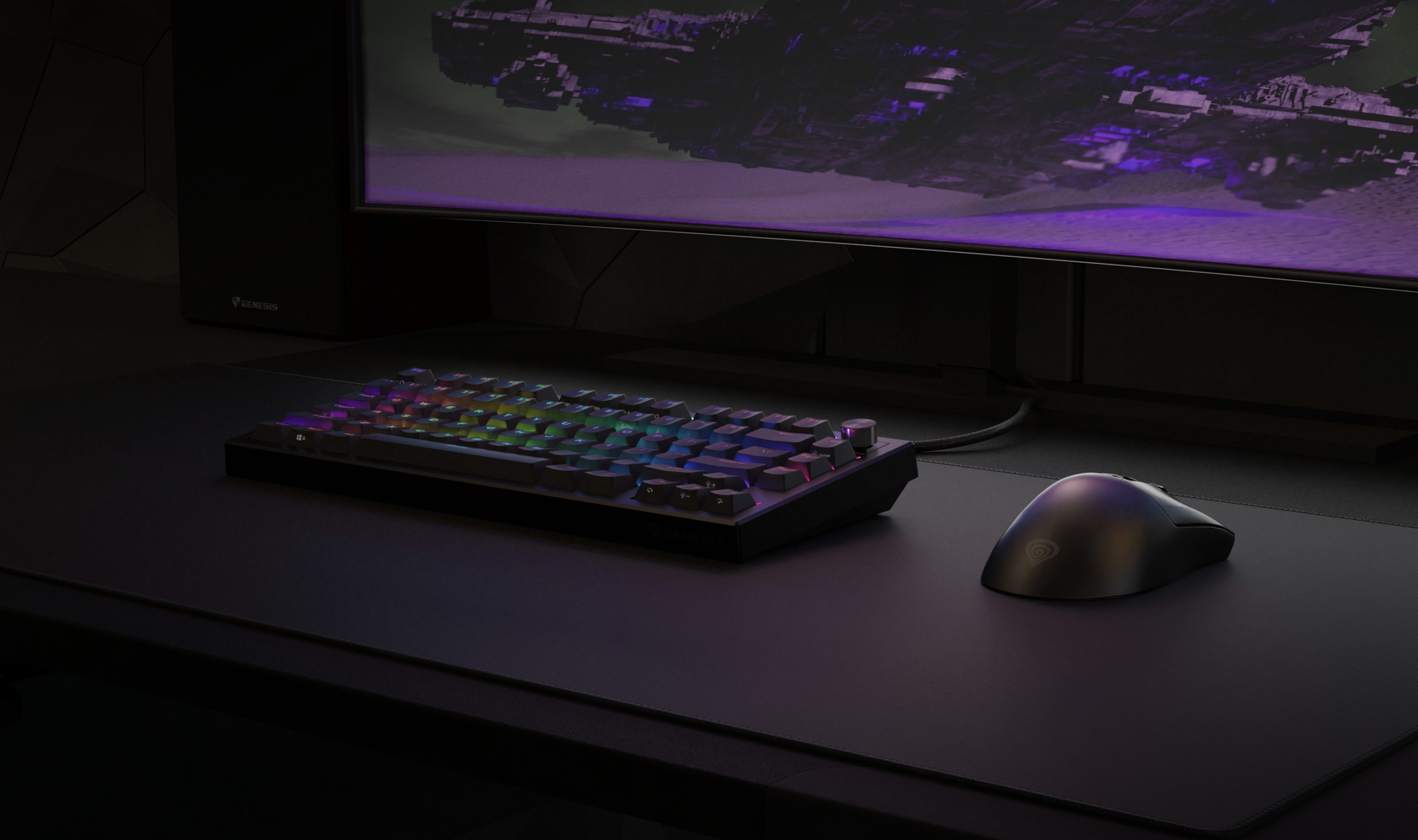 Keyboard with colorful lighting and a mouse on a dark desk, with a screen in the background.