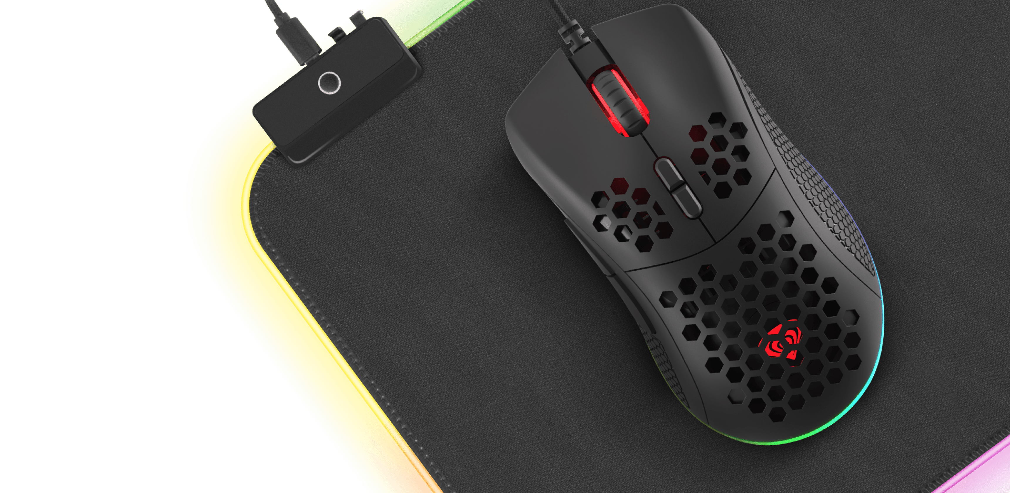 Black Genesis Krypton 550 gaming mouse with RGB lighting, 8000 DPI, and programmable features, placed on a gaming mousepad