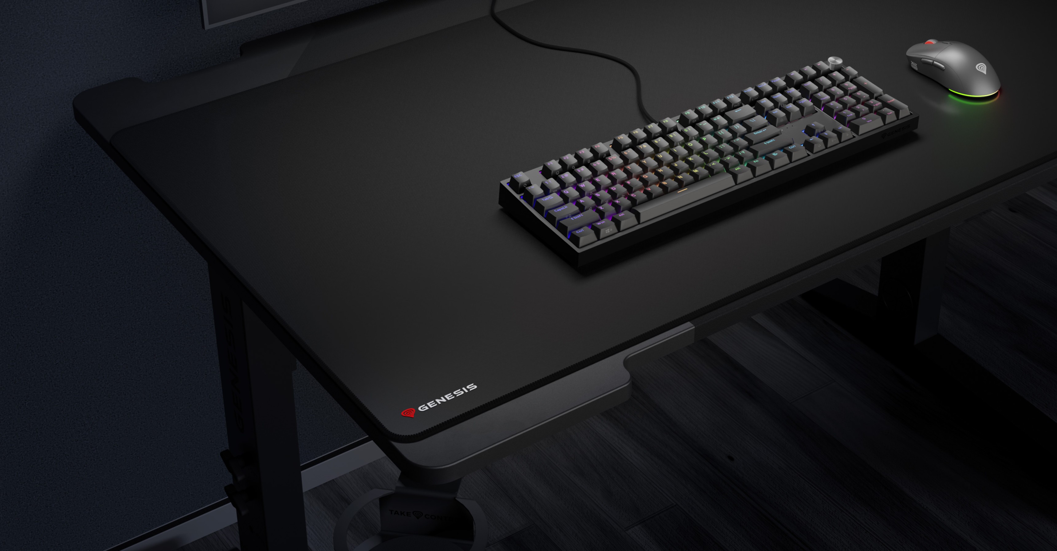 Large black mouse pad on a desk with a keyboard and a mouse