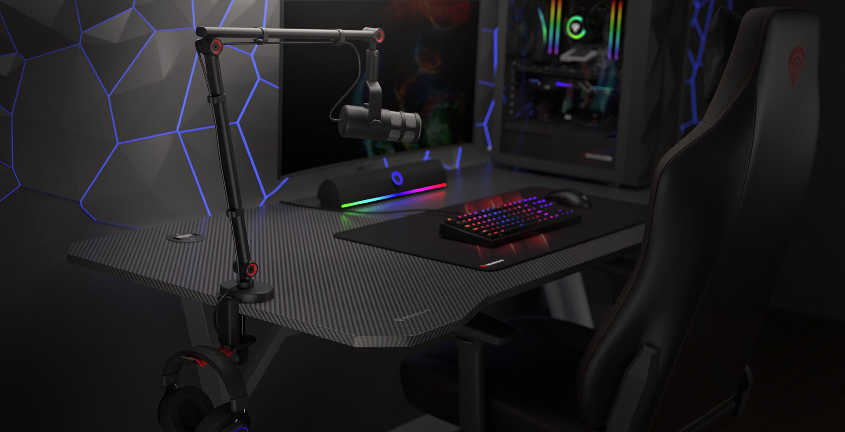Microphone arm with a headset holder, positioned on a sleek gaming desk featuring a keyboard and colorful lighting