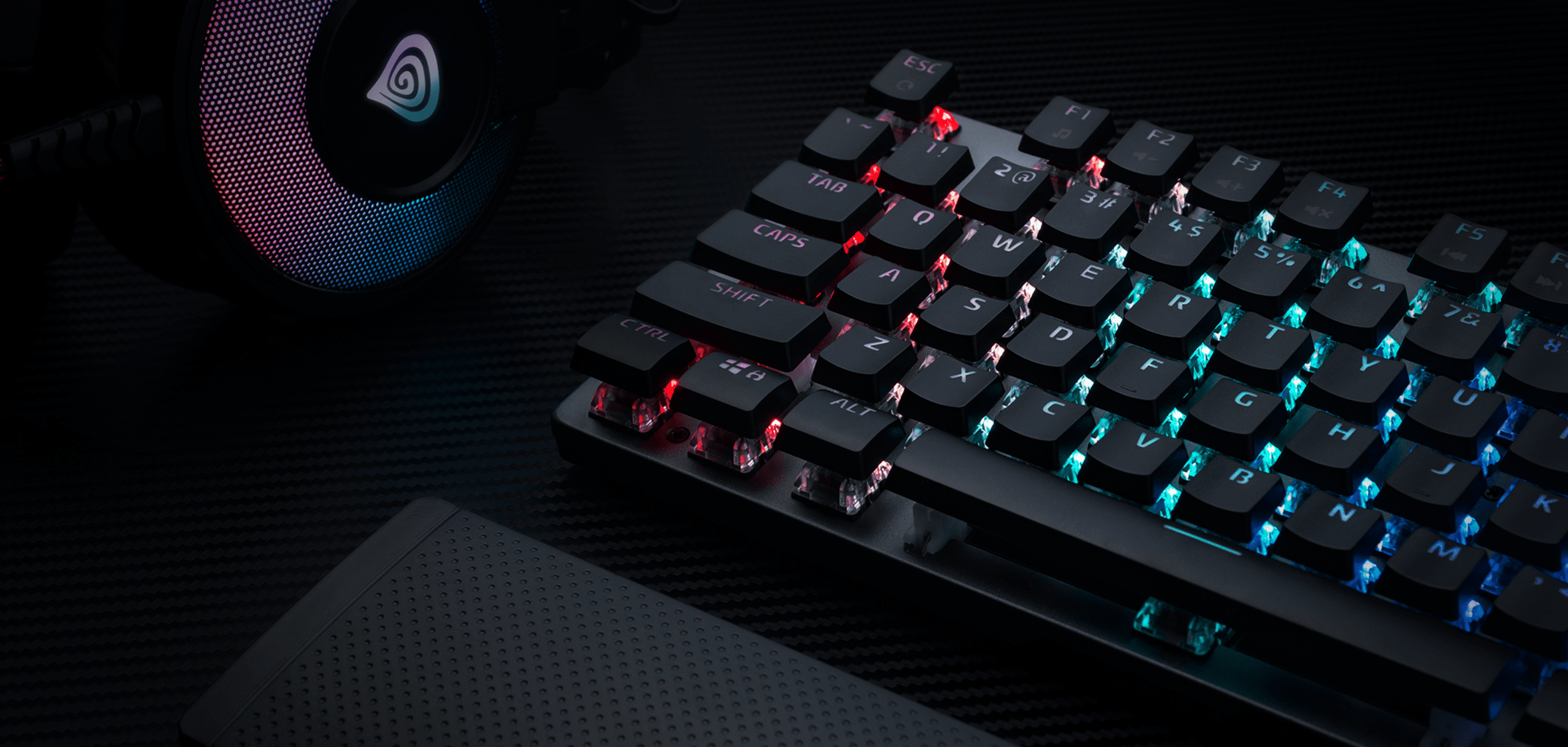 A keyboard with illuminated keys in various colors and a stylish gaming headset.