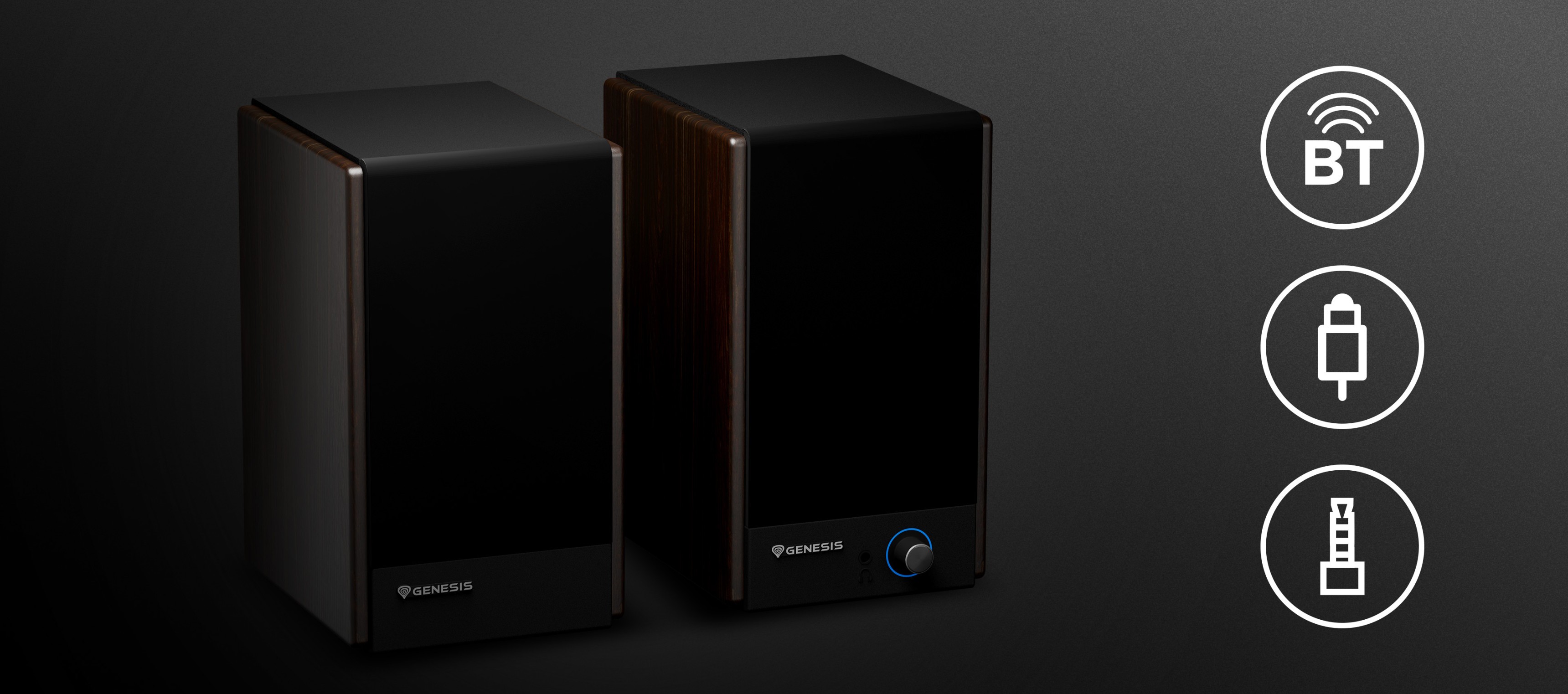 Two audio speakers with sleek black surfaces and a circular control knob on one speaker.