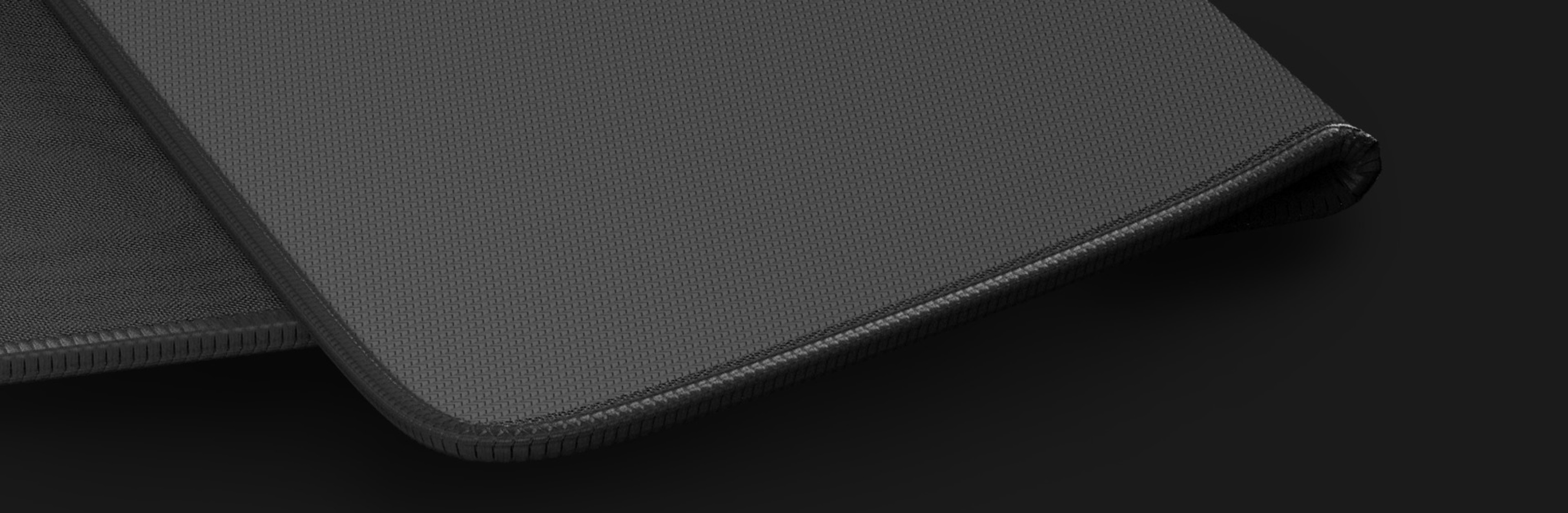 Large black mouse pad with a textured surface and stitched edges, measuring 500x400mm