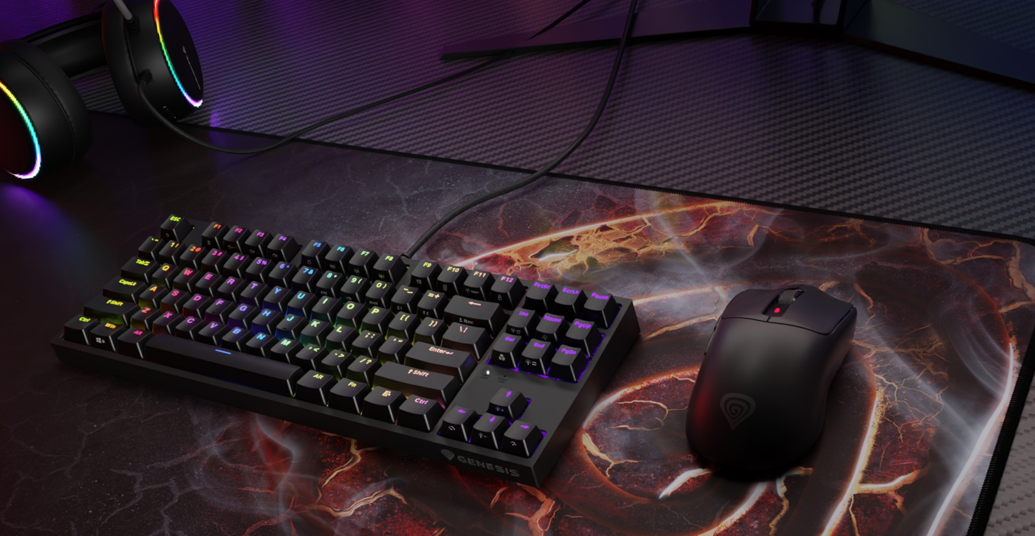 A gaming keyboard with colorful backlighting next to a gaming mouse on a branded mouse pad.