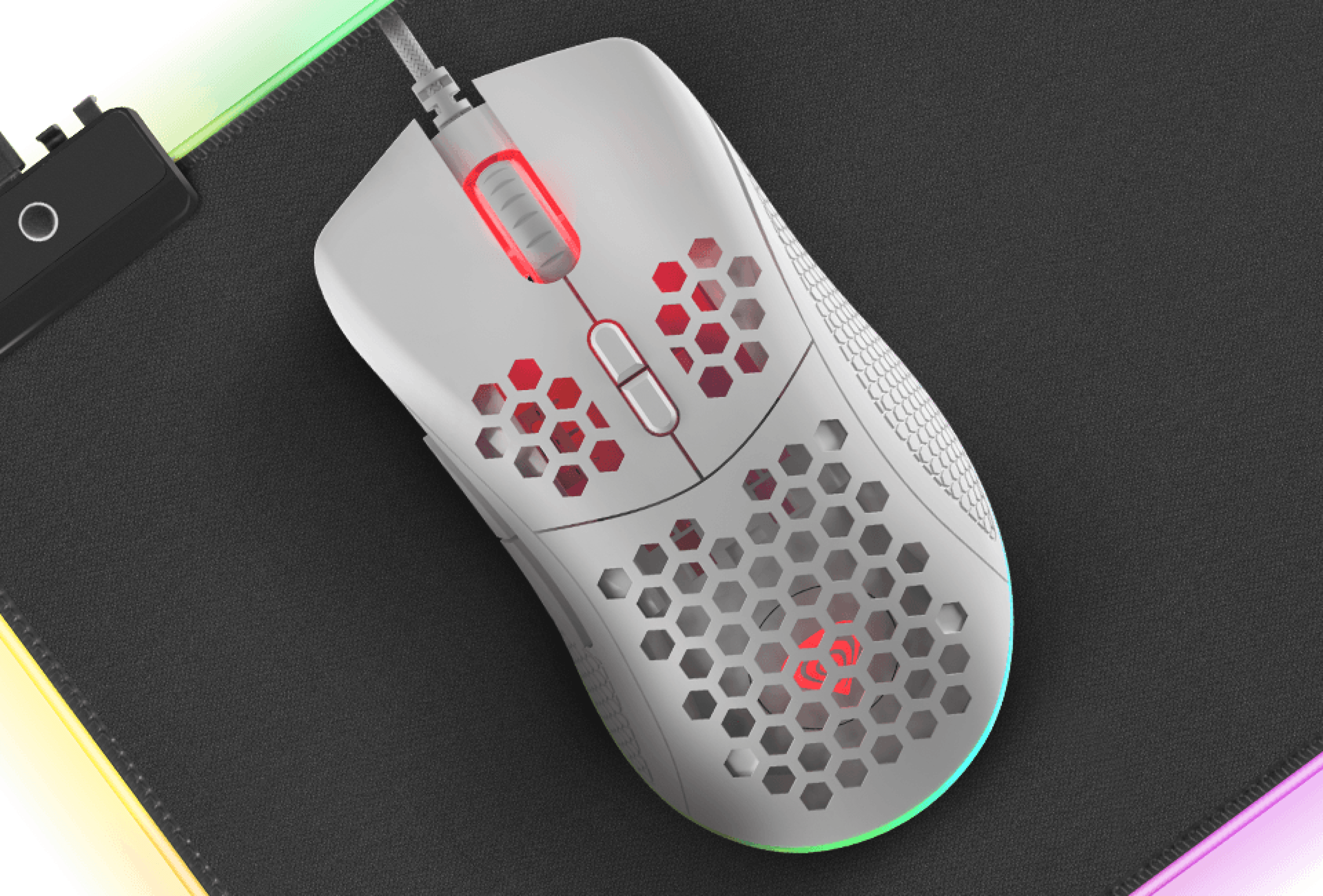 Gaming mouse with a textured surface and glowing elements on a mouse pad.