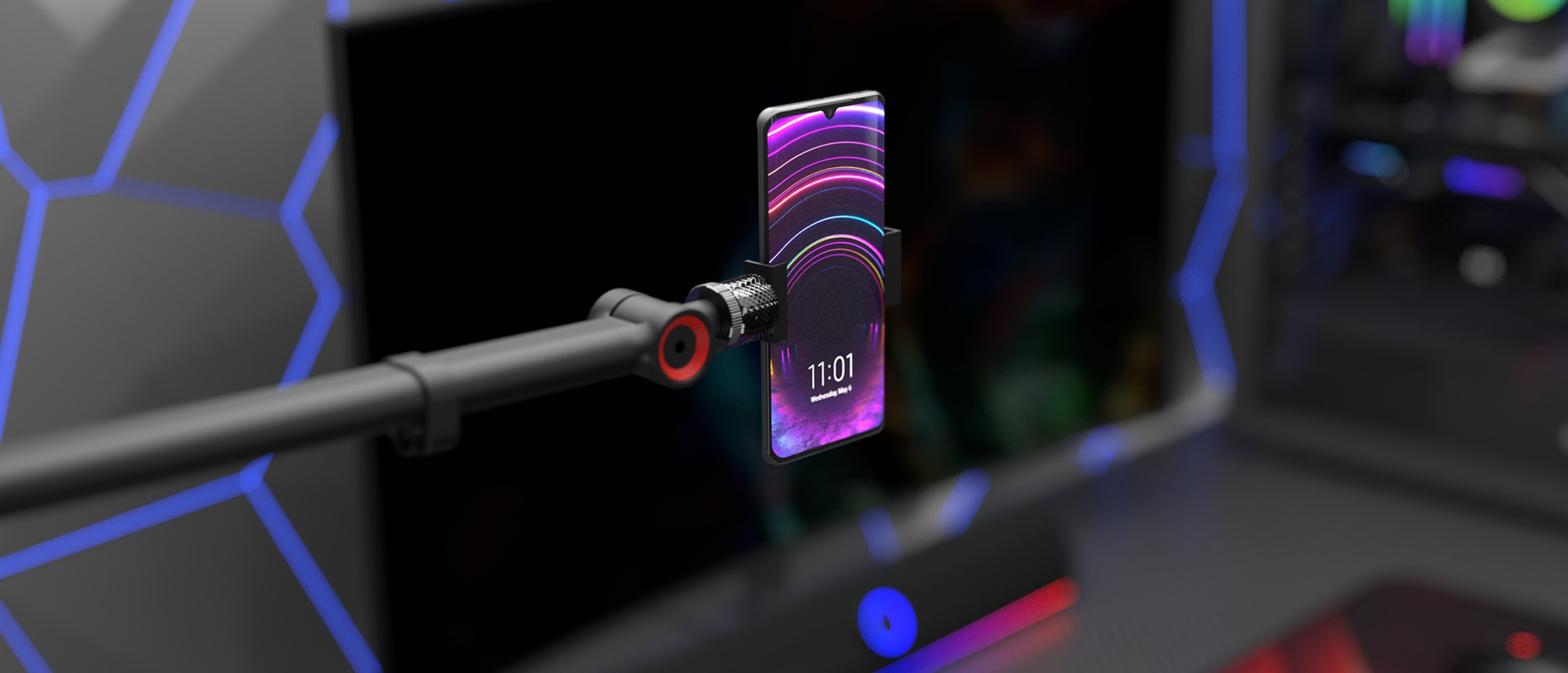 Microphone arm with a phone attached, featuring a colorful design, mounted on a gaming setup with LED accents