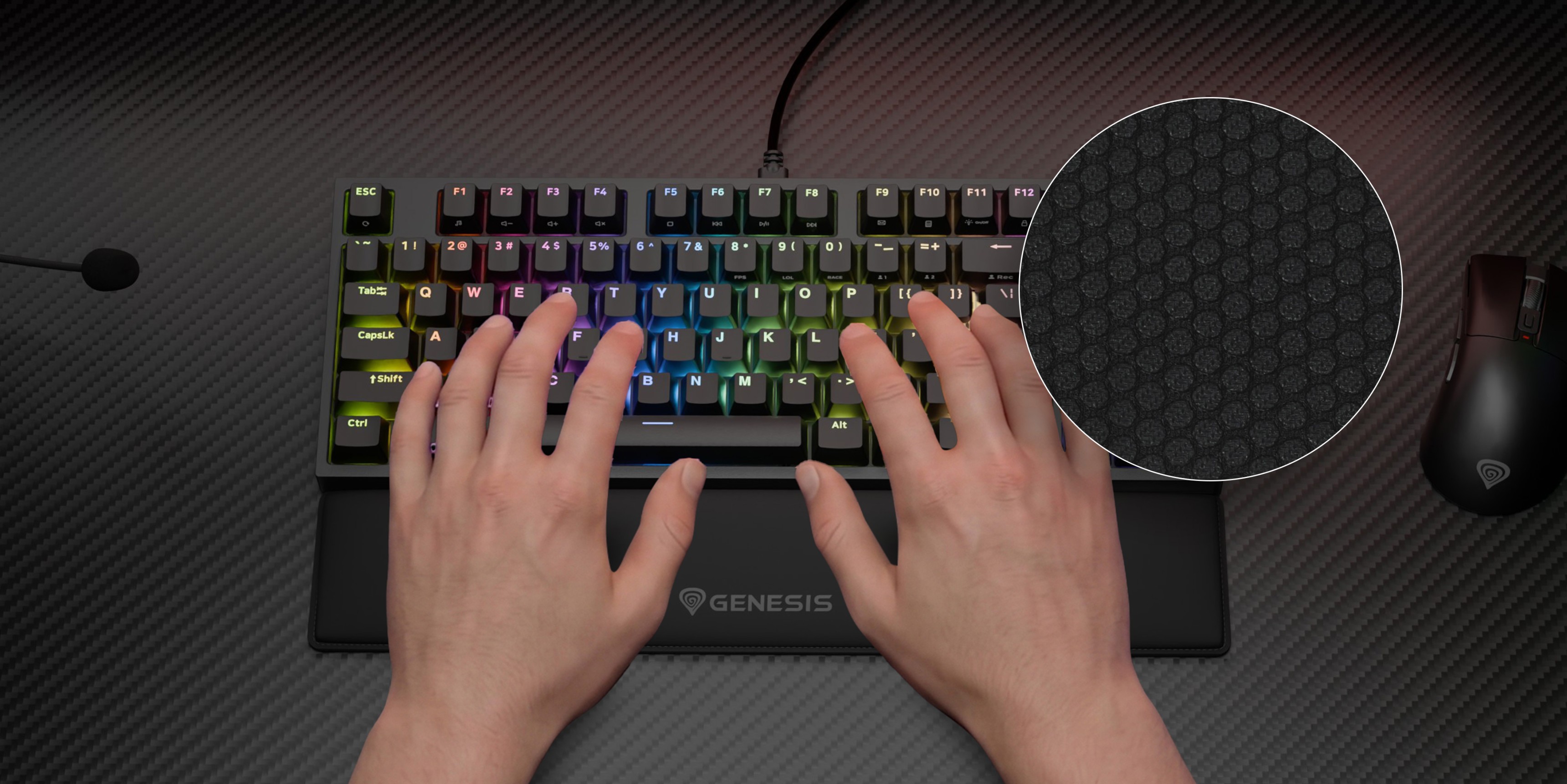 Hands on a colorful keyboard with a mouse and a textured surface in the background.