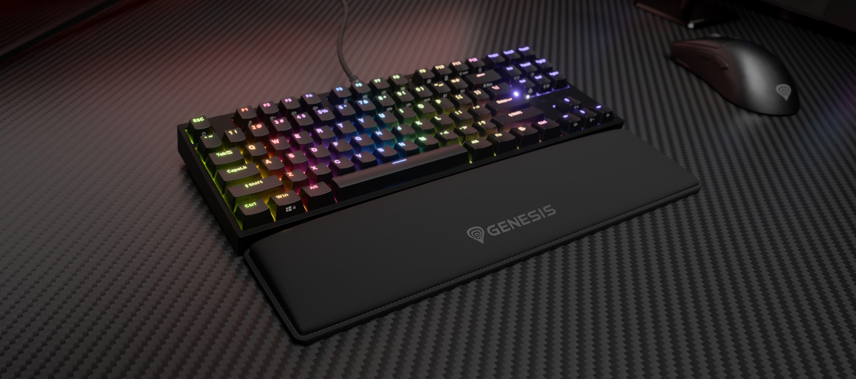 Keyboard with colorful backlighting and a wrist rest on a textured surface.