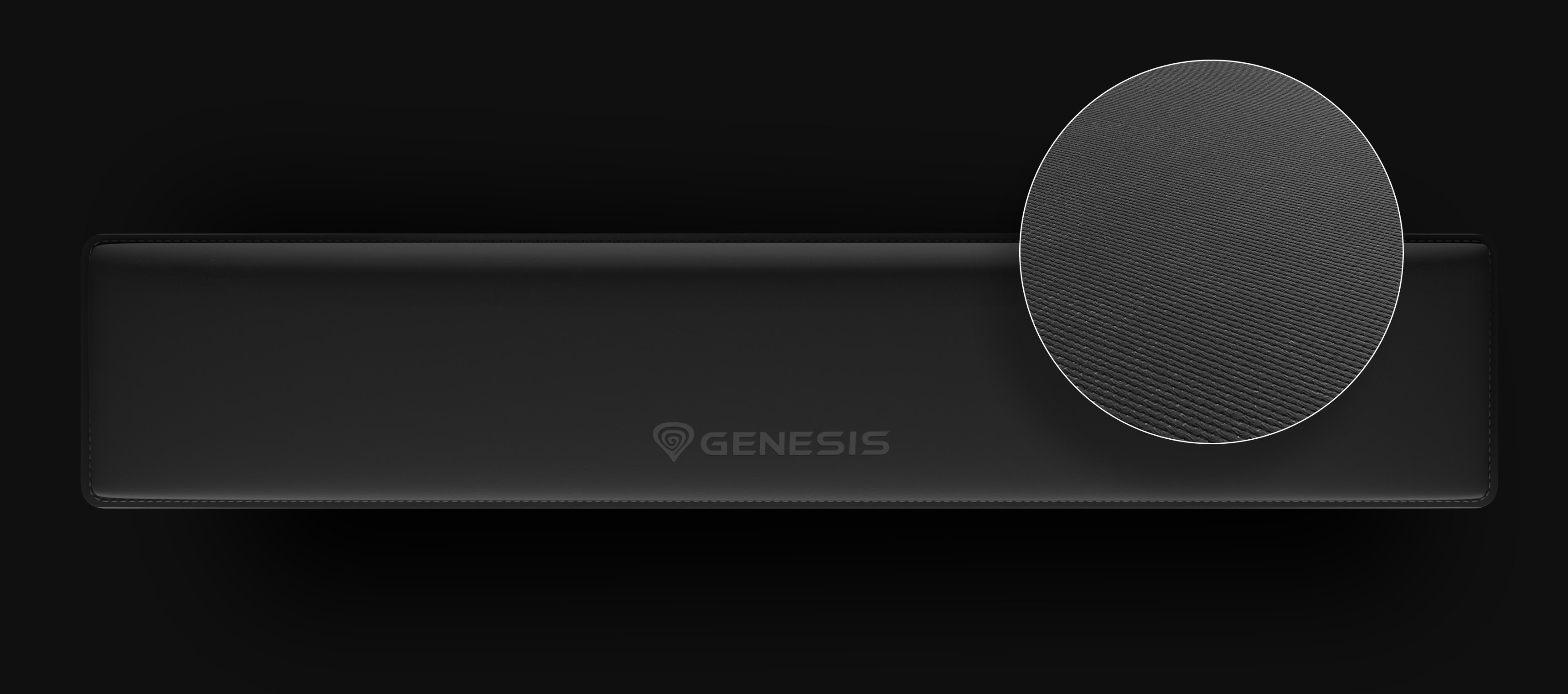 Long black device with a textured circular section on top and a logo in the center.