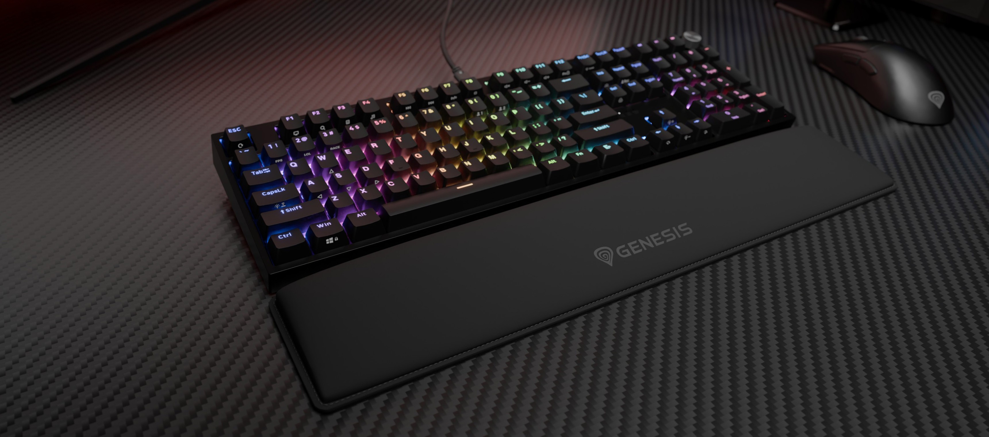 Keyboard with colorful backlighting and a soft wrist rest on a textured surface.